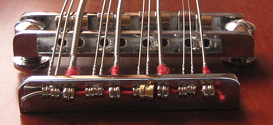 Another method for anchoring strings with small ball ends which uses a piece of bass string.
