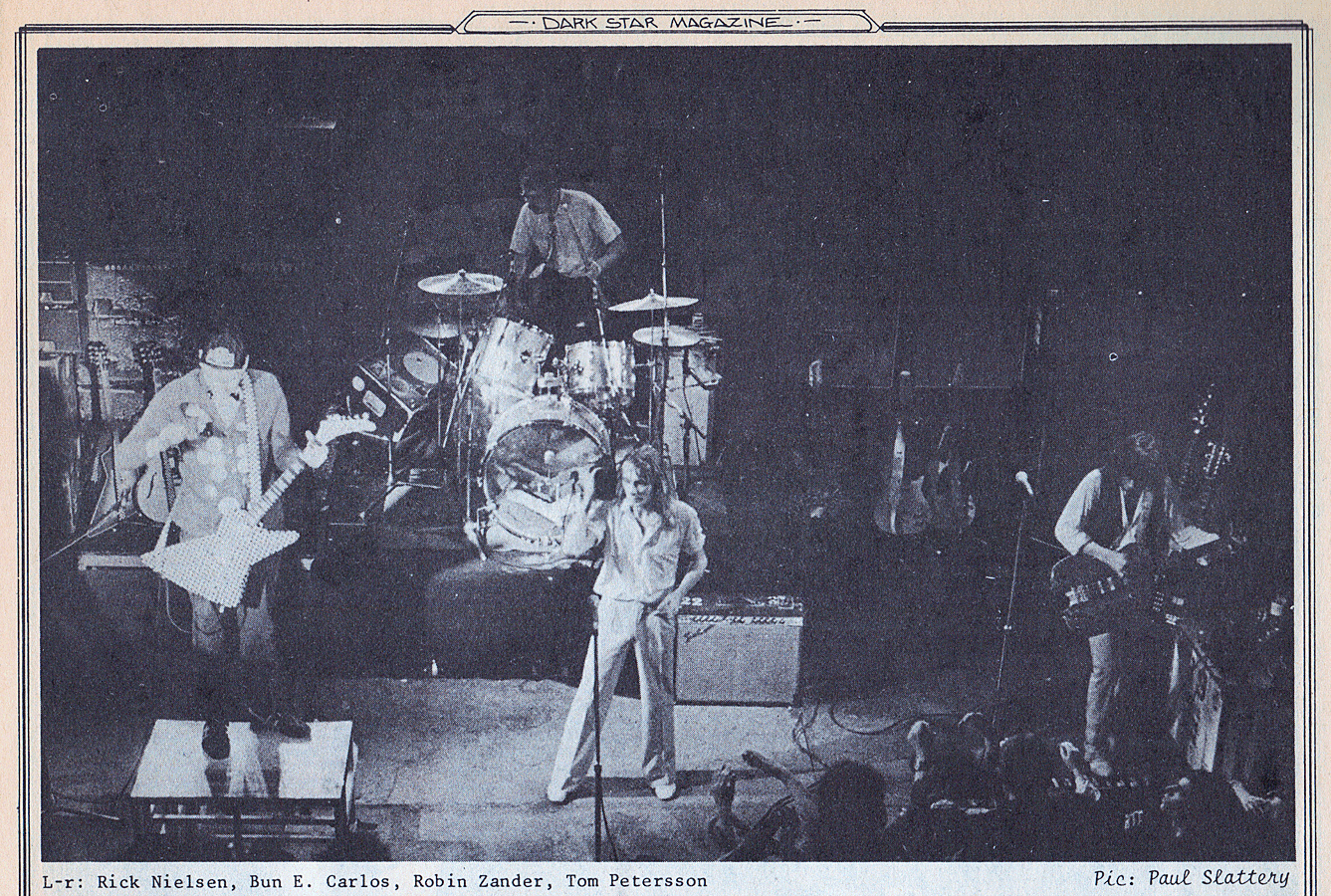 The Hamer 12-string Quad Bass is visible behind Petersson, who is playing the Alembic 8-string bass.
