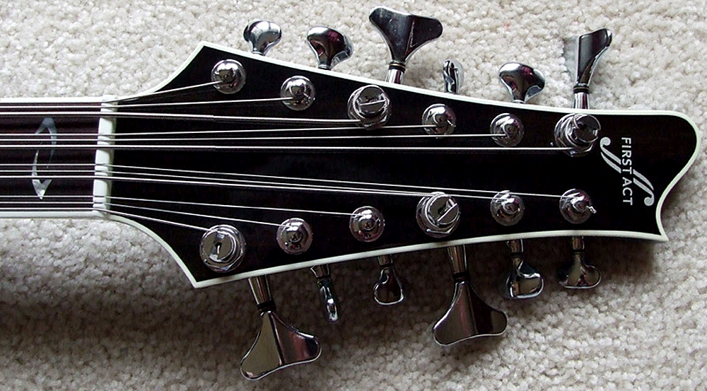 Headstock of the First Act Reverse Delgada 12-string bass.