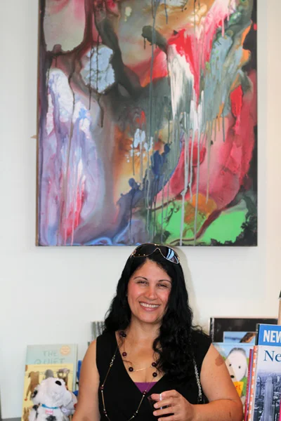 Farideh in front of artwork "Virgin Nature" at her exhibit in RiverRead Bookstore (NY, 2012)