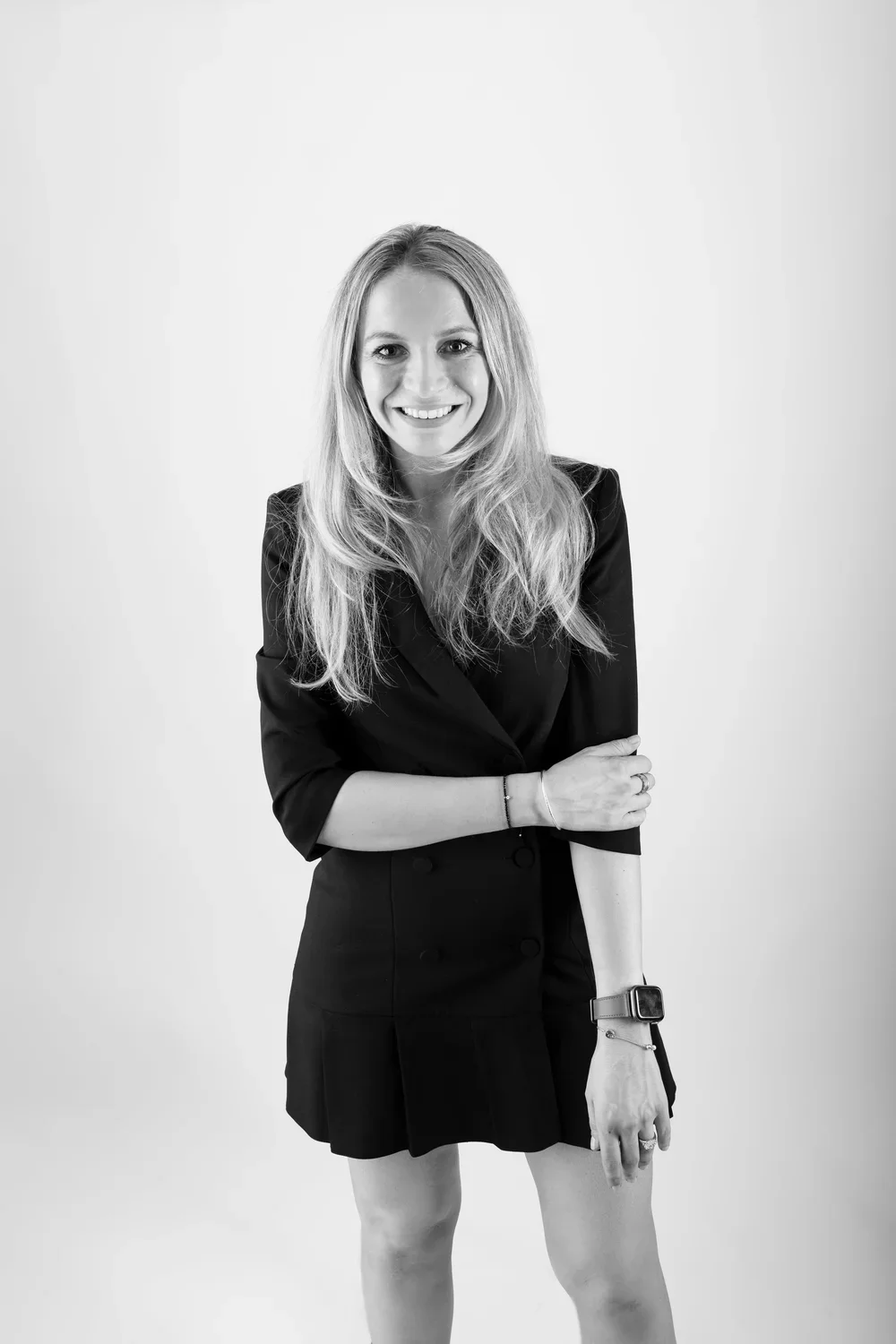 Black and white photo of the founder of SPEAK Communications standing against a plain light background.