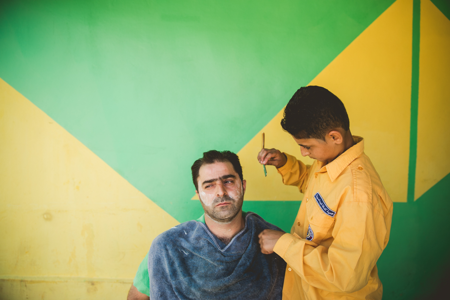  Yasar Taha, a 15-year-old Syrian refugee, works illegally as a barber as well as in a local restaurant while attempting to go to school. If he stops working his family might lose the tent they live in, as they rely on his income along with his fathe