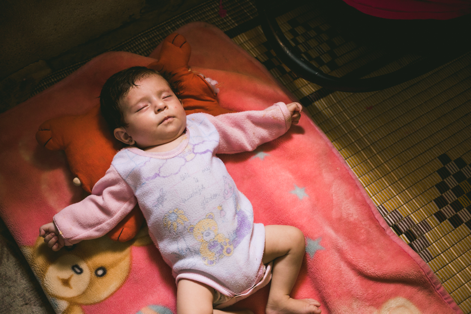  A newborn baby sleeping in an “unofficial” refugee camp in the Bekaa Valley. 