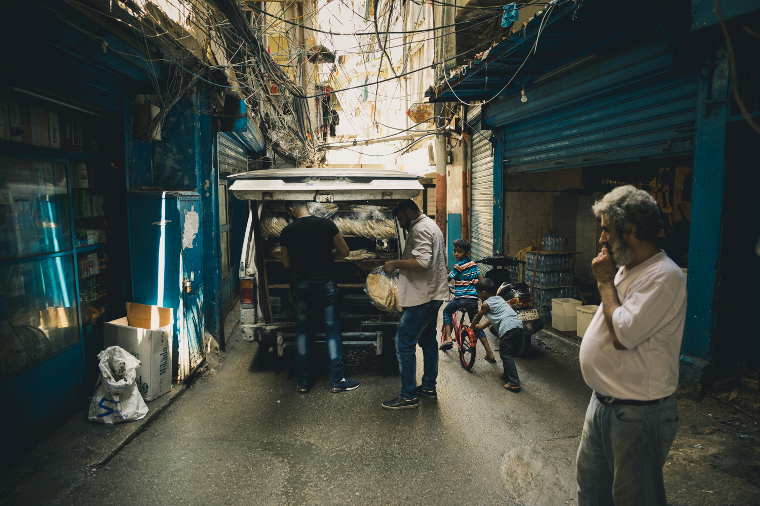  A bread truck unloading on one of the narrow streets of the Shatila camp. 