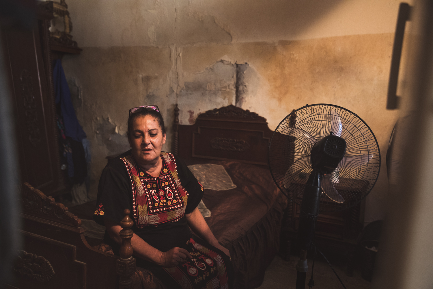  An elderly woman in her small room. 