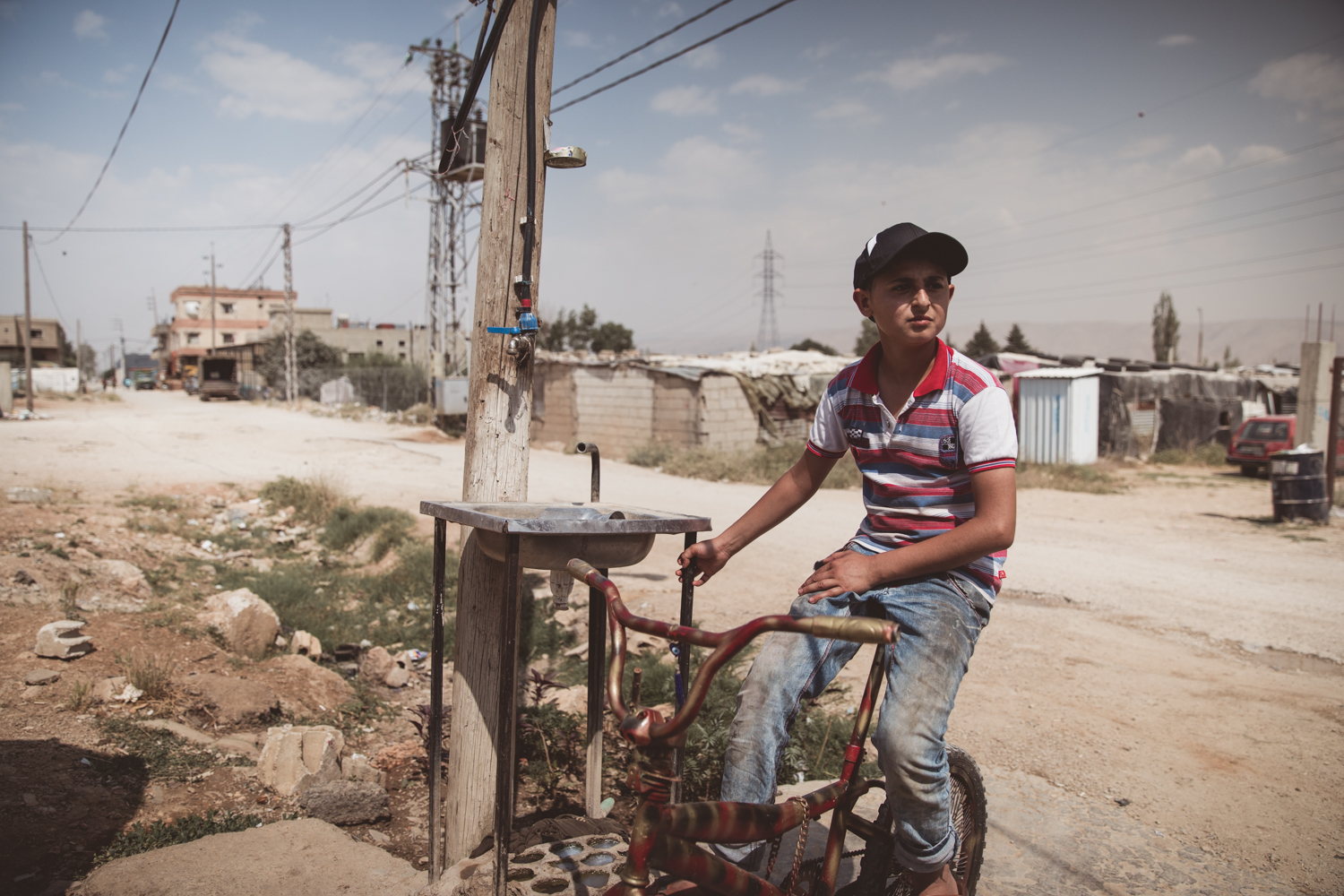  Yasar Taha, sitting on his bike outside the camp where he lives. 