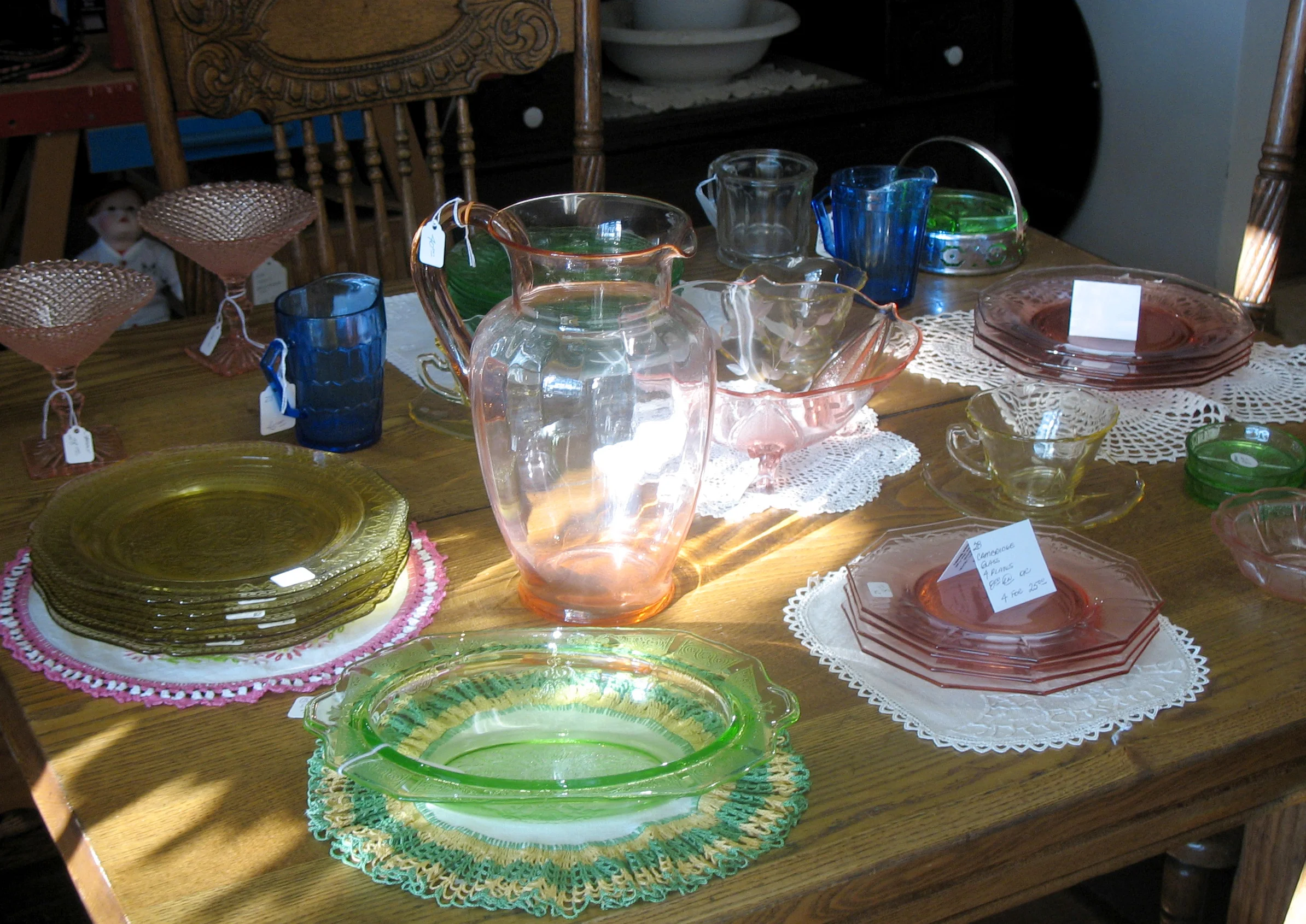 Depression Glass pieces pictured above include: Pink Cambridge Glass Plates, Cobalt Aurora Creamer, Amber Patrician Luncheon Plates, Pink Cherry Blossom Berry Bowl, Green Princess Oval Vegetable Bowl