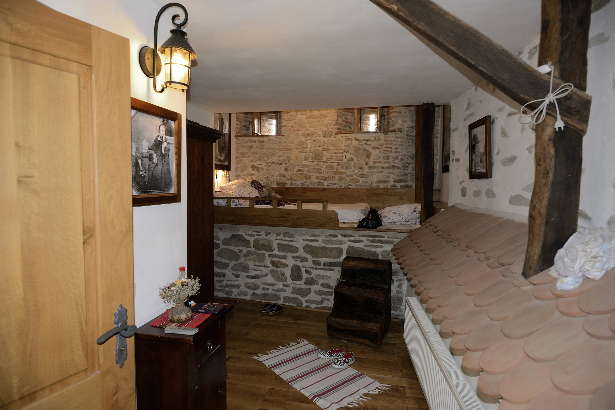 Room in Sighisoara Inn with bed on the city wall,arrowslits for windows