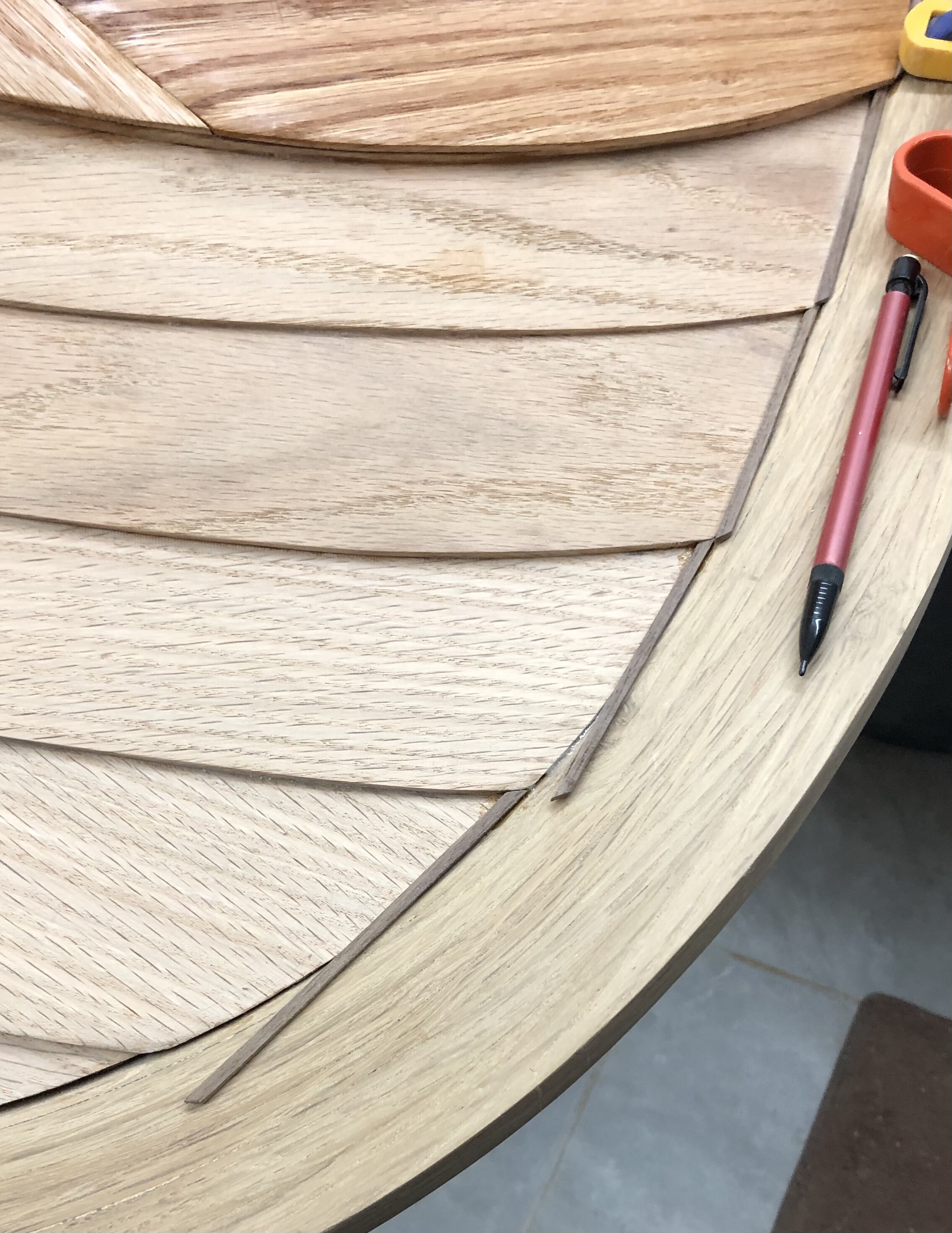 Walnut strips inlaid where planks meet the keel
