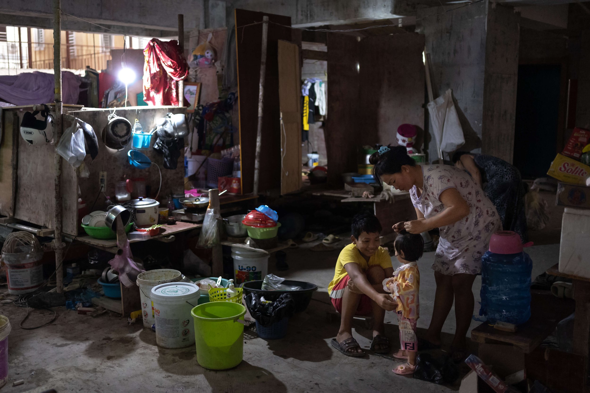  A family living on the site at Bassac lane. An estimated 50 workers live on-site, some with their family, in makeshift shelters made from scaffolding and wood. 