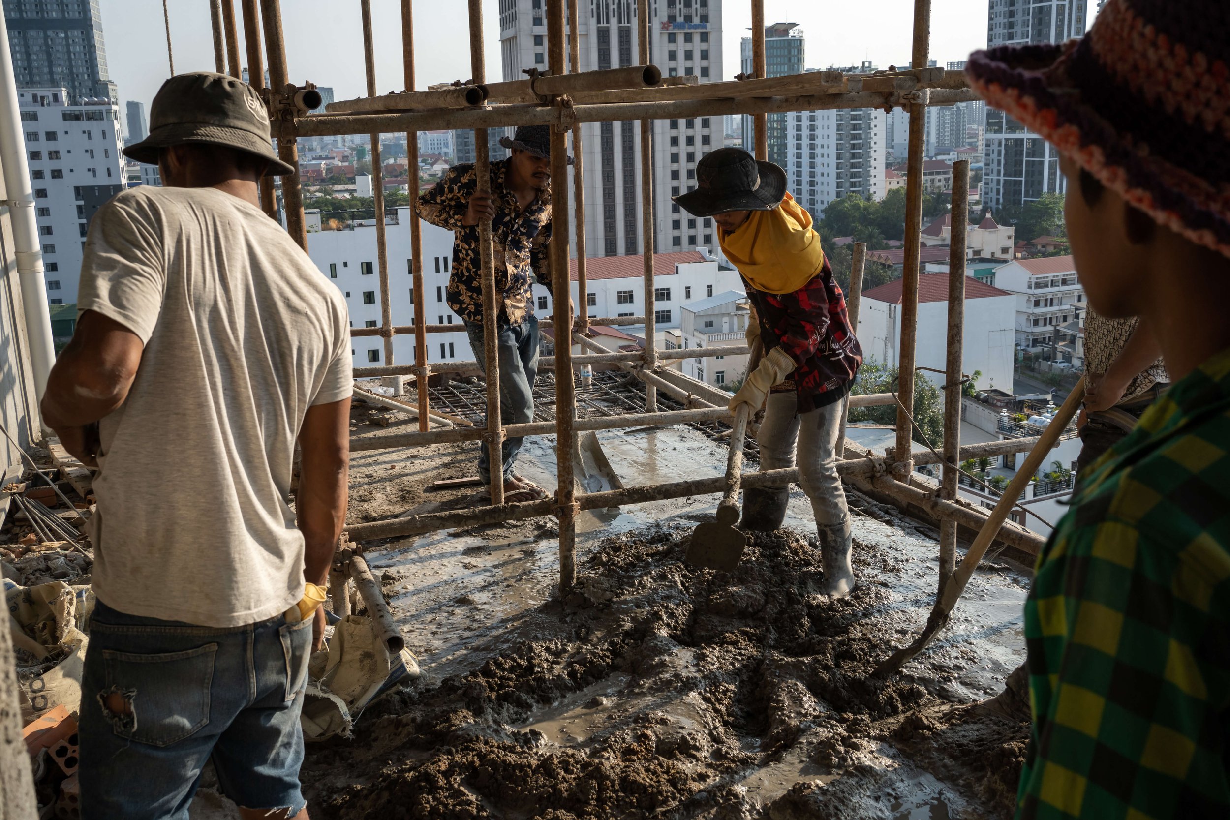  Construction workers lay concrete on the 8th floor of the site at Bassac Lane. 