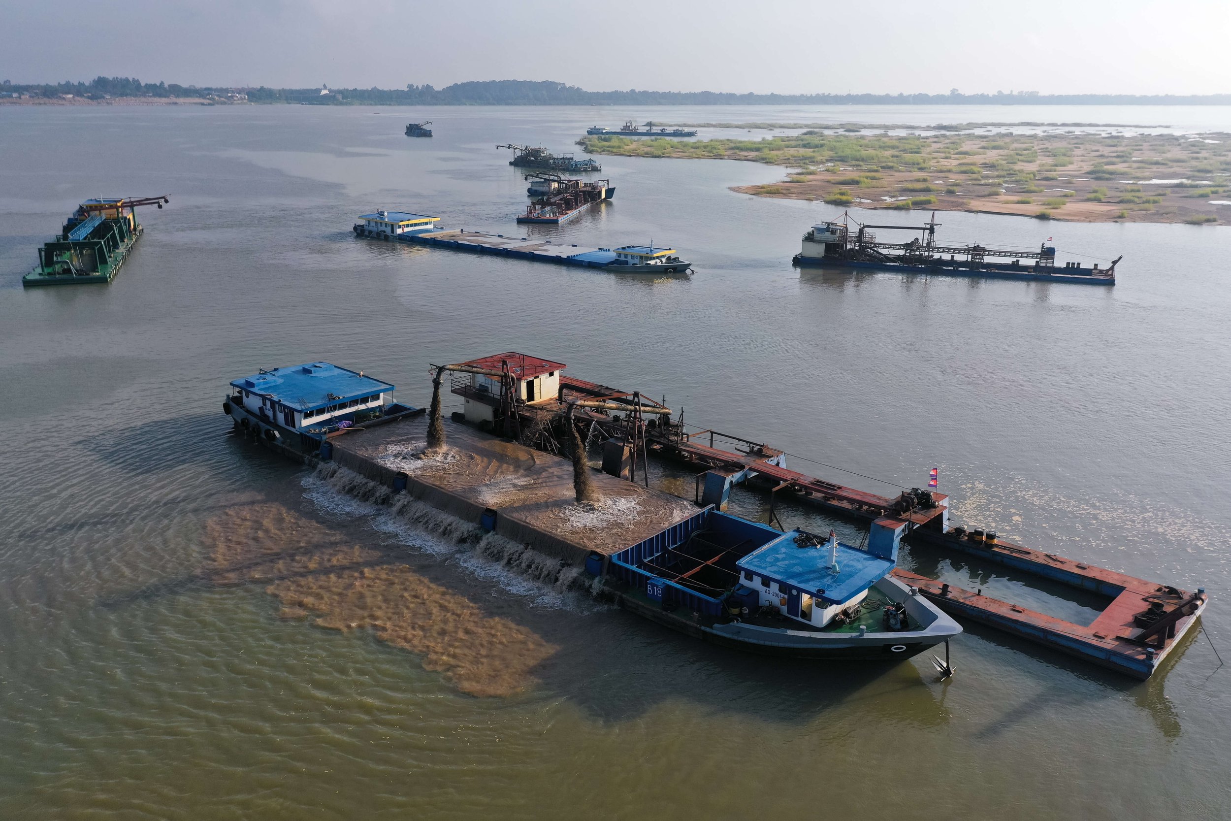  Sand mining barges extract sand in Rokar Koang Commune. Along with being one of the most heavily mined stretches of the Mekong in Cambodia, it was also the site of two riverbank collapses in 2021. The mined sand is shipped to the capital Phnom Penh 