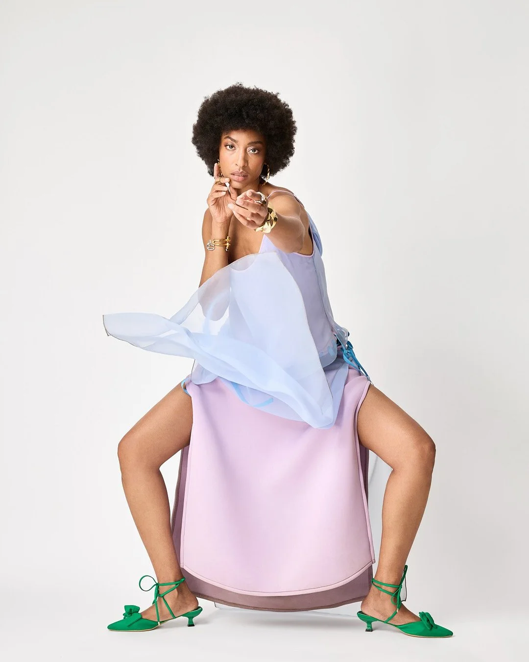 Model in a sculptural lavender outfit with flowing pale-blue fabric and green heels, photographed by Sam Eltosam for Papa Oppong.