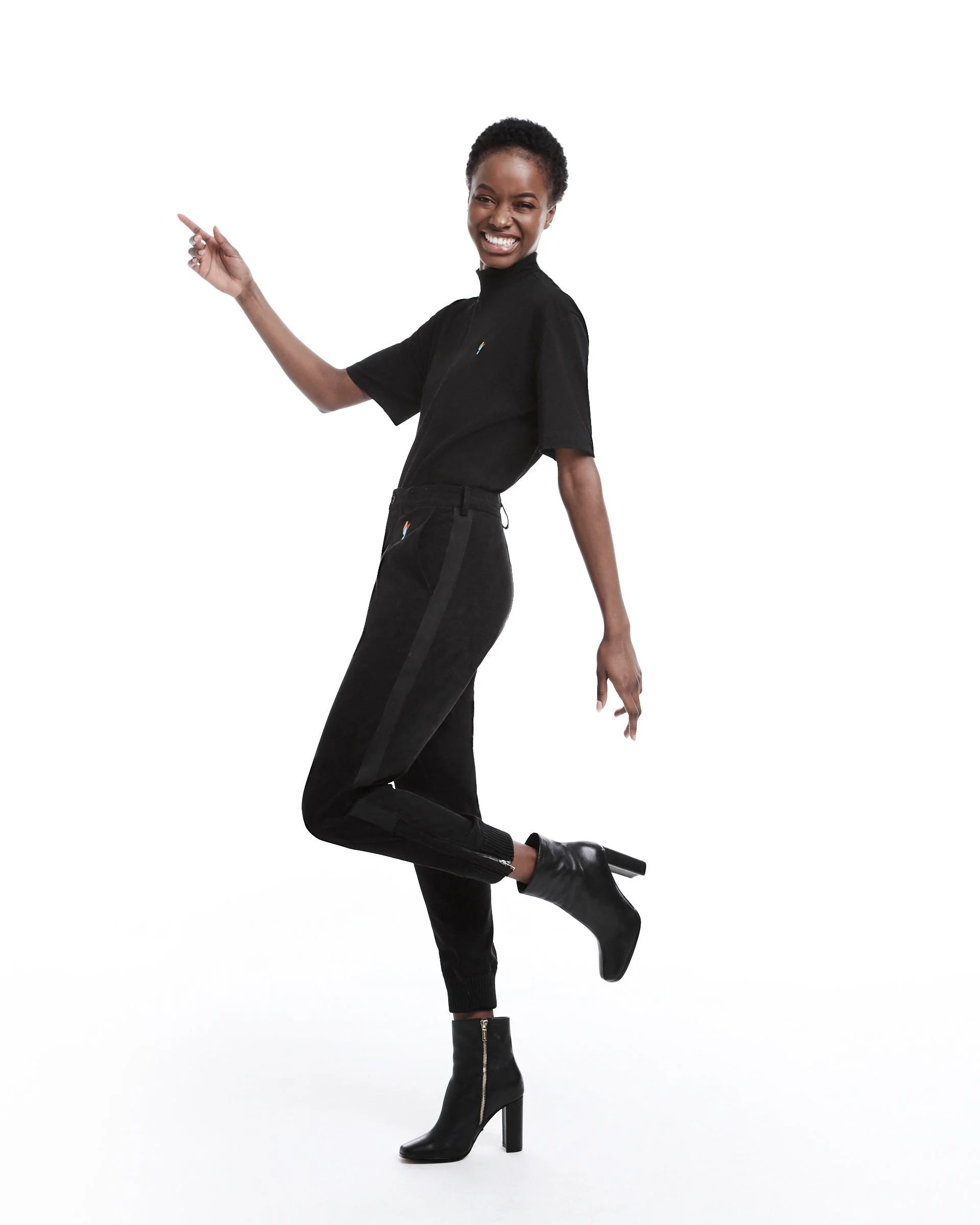 Fashion editorial photo of a female model in a black high-neck top dancing, shot by Seltosamarts Photography in New York.