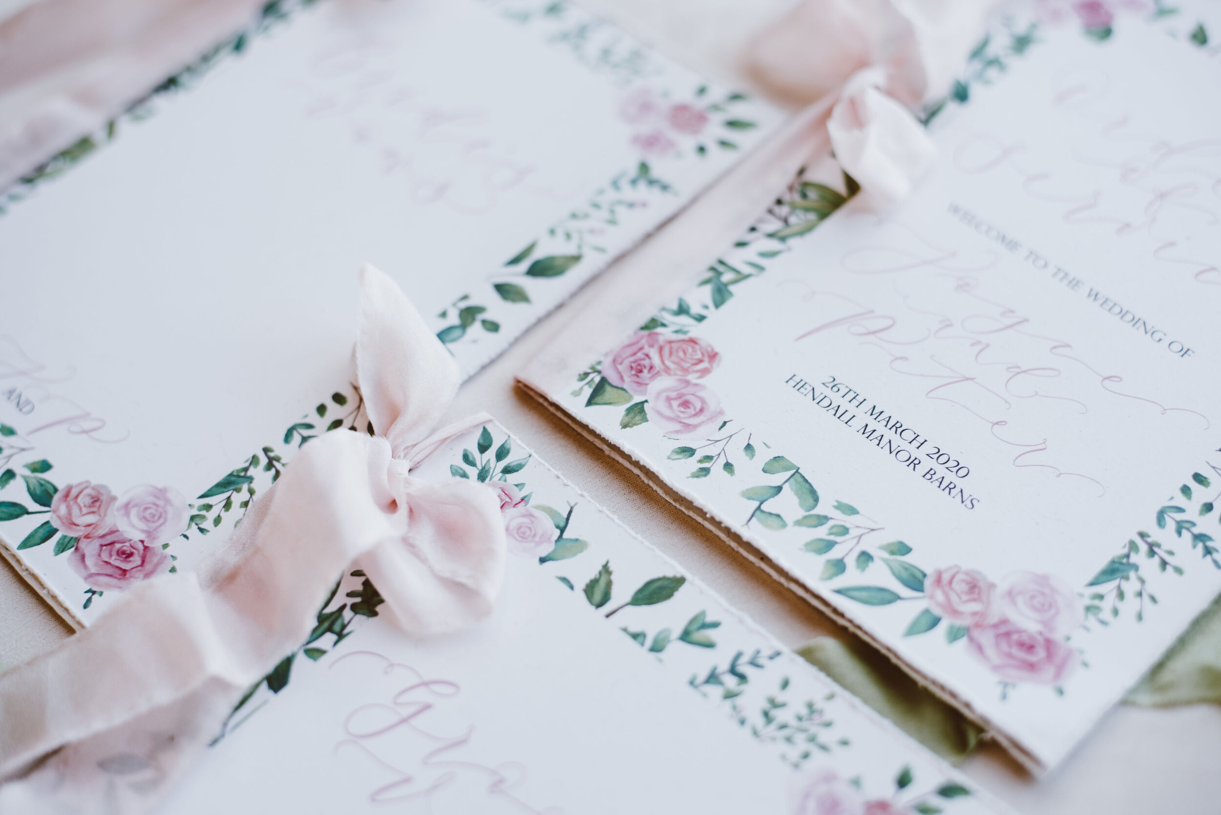Luxury recycled floral wedding invites with pink roses and greenery and hand-lettered calligraphy by The Amyverse