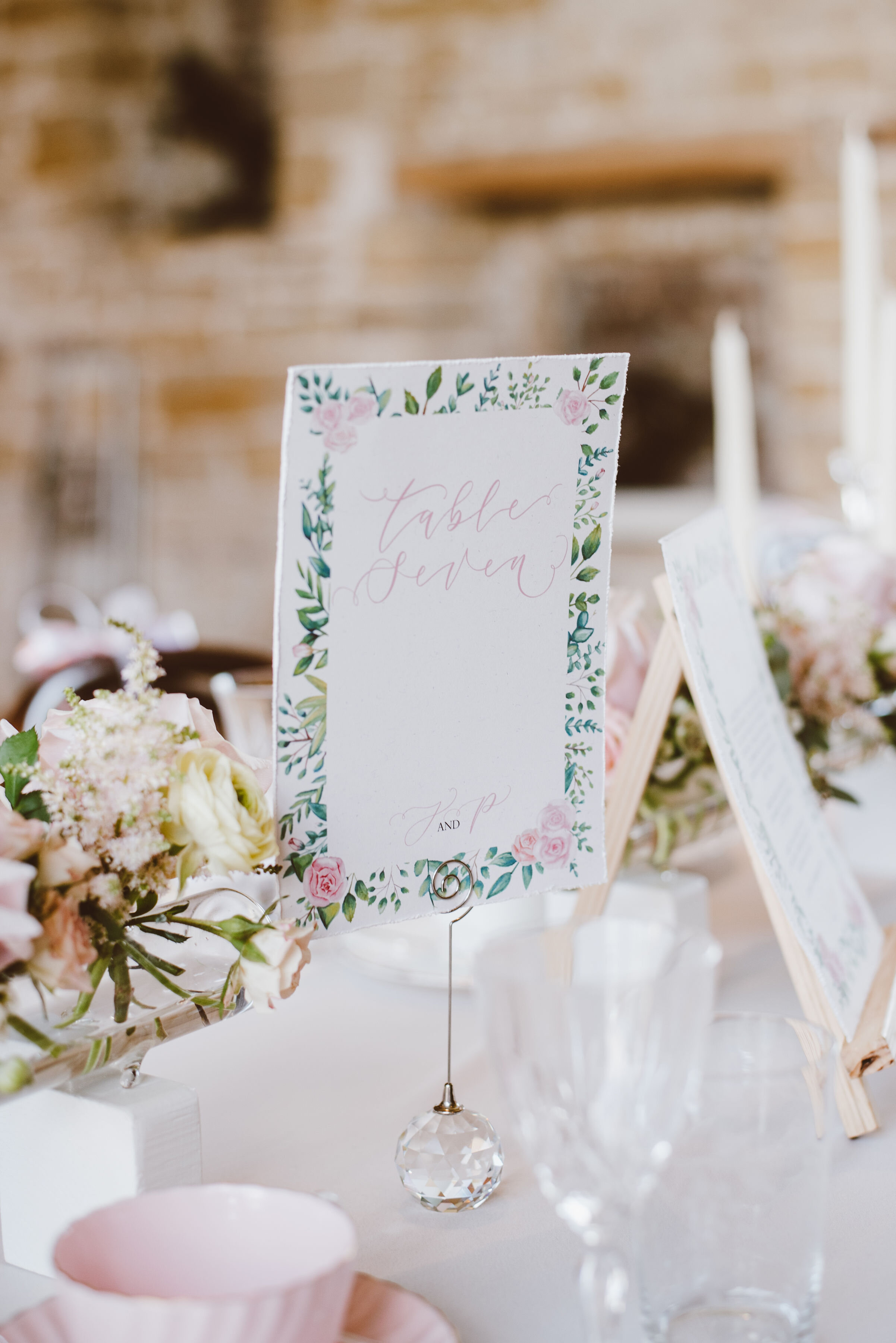 Luxury recycled paper floral  table number  with pink roses and greenery and hand-lettered calligraphy by The Amyverse - Eco friendly wedding stationery