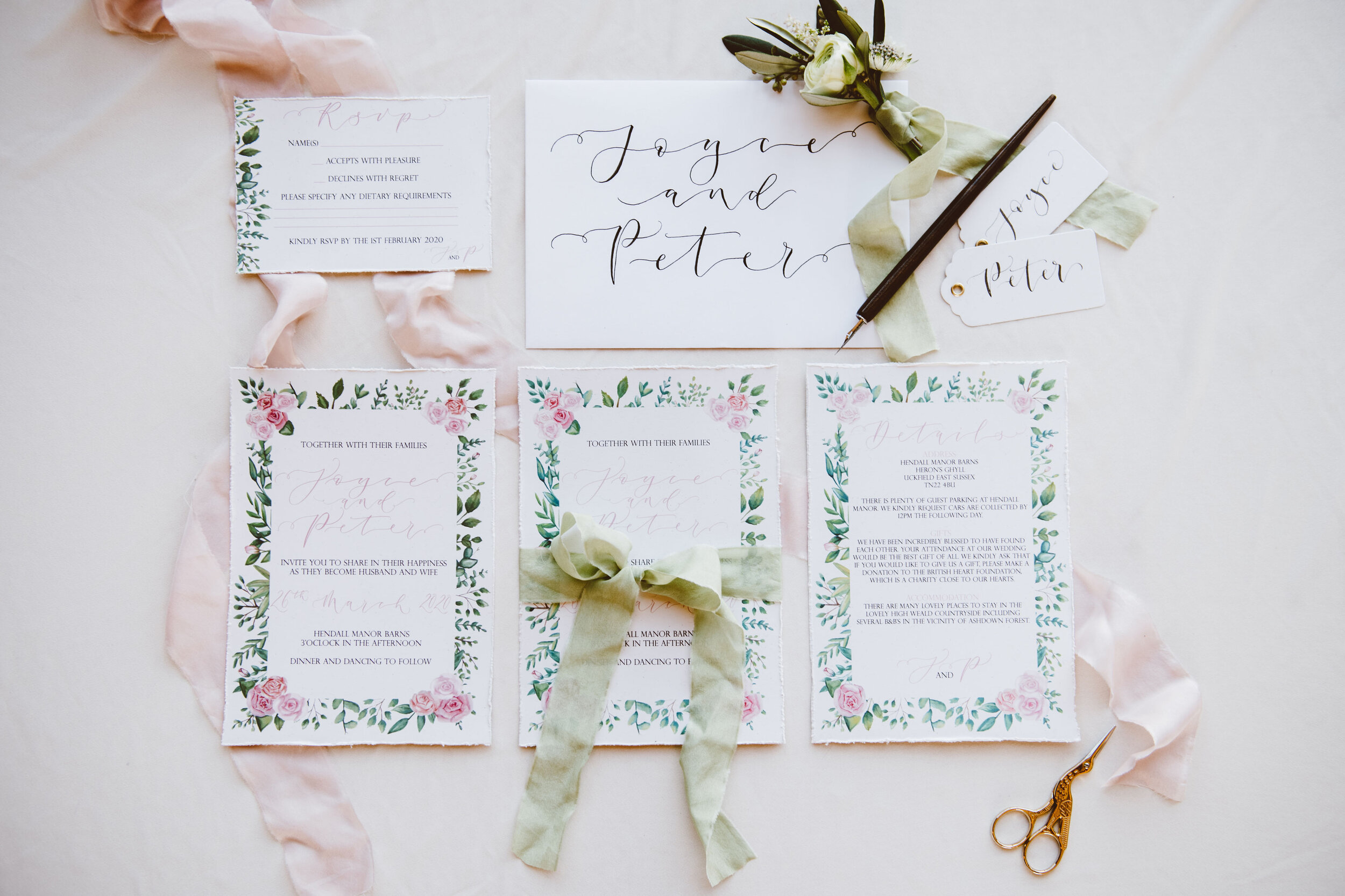 Luxury recycled floral wedding stationery suite with pink roses and greenery and hand-lettered calligraphy by The Amyverse