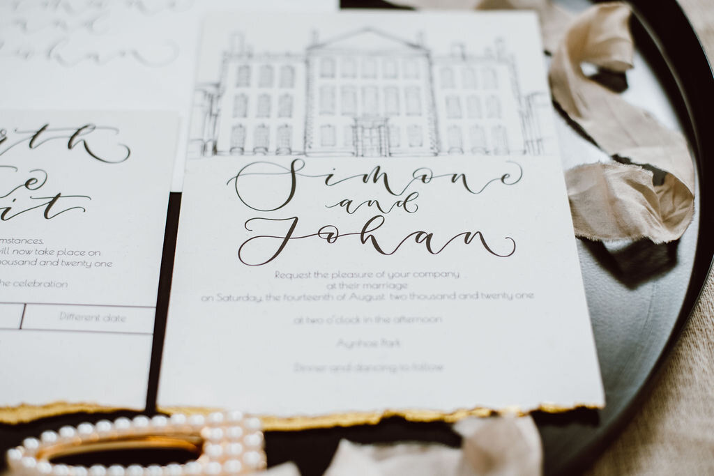 Monochrome Aynhoe Park invitation suite printed on recycled paper with gold details by The Amyverse with illustrated timeline and venue sketch  - gold detail.jpg