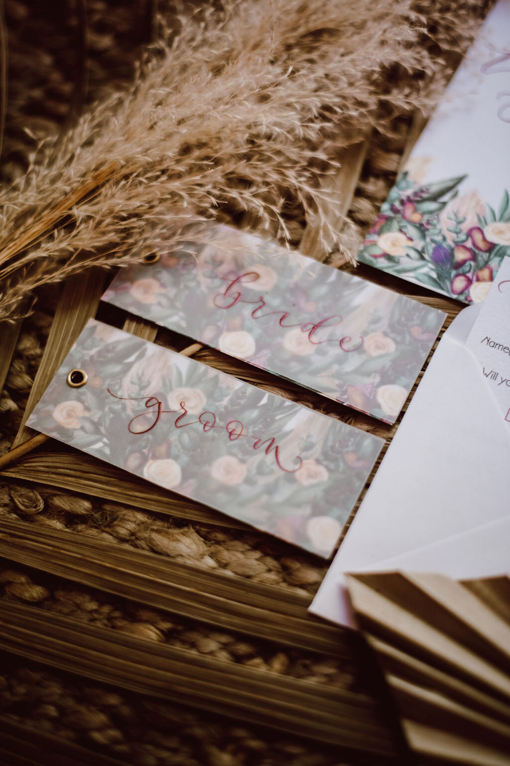 Burgundy calligraphy place cards  on vellum with watercolour painted pampass grass, roses, thistles.jpg