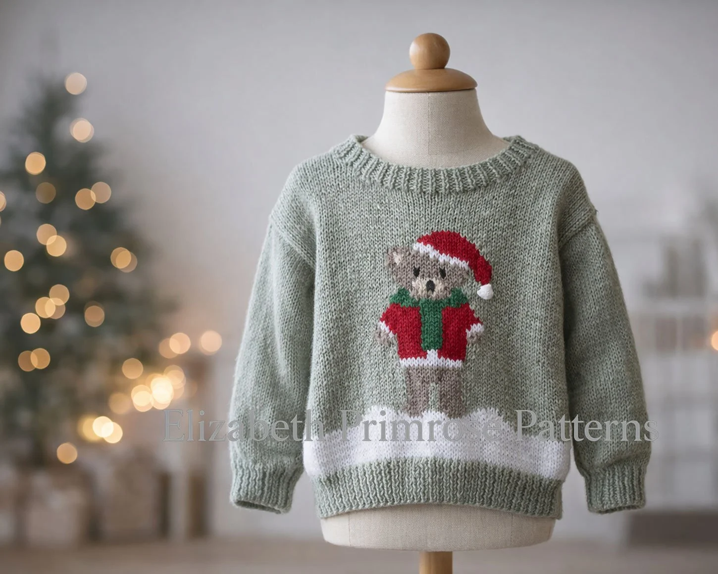 Festive knitted jumper with bear motif wearing red hat and jacket, shown on child’s mannequin against blurred minimalist Christmas background.