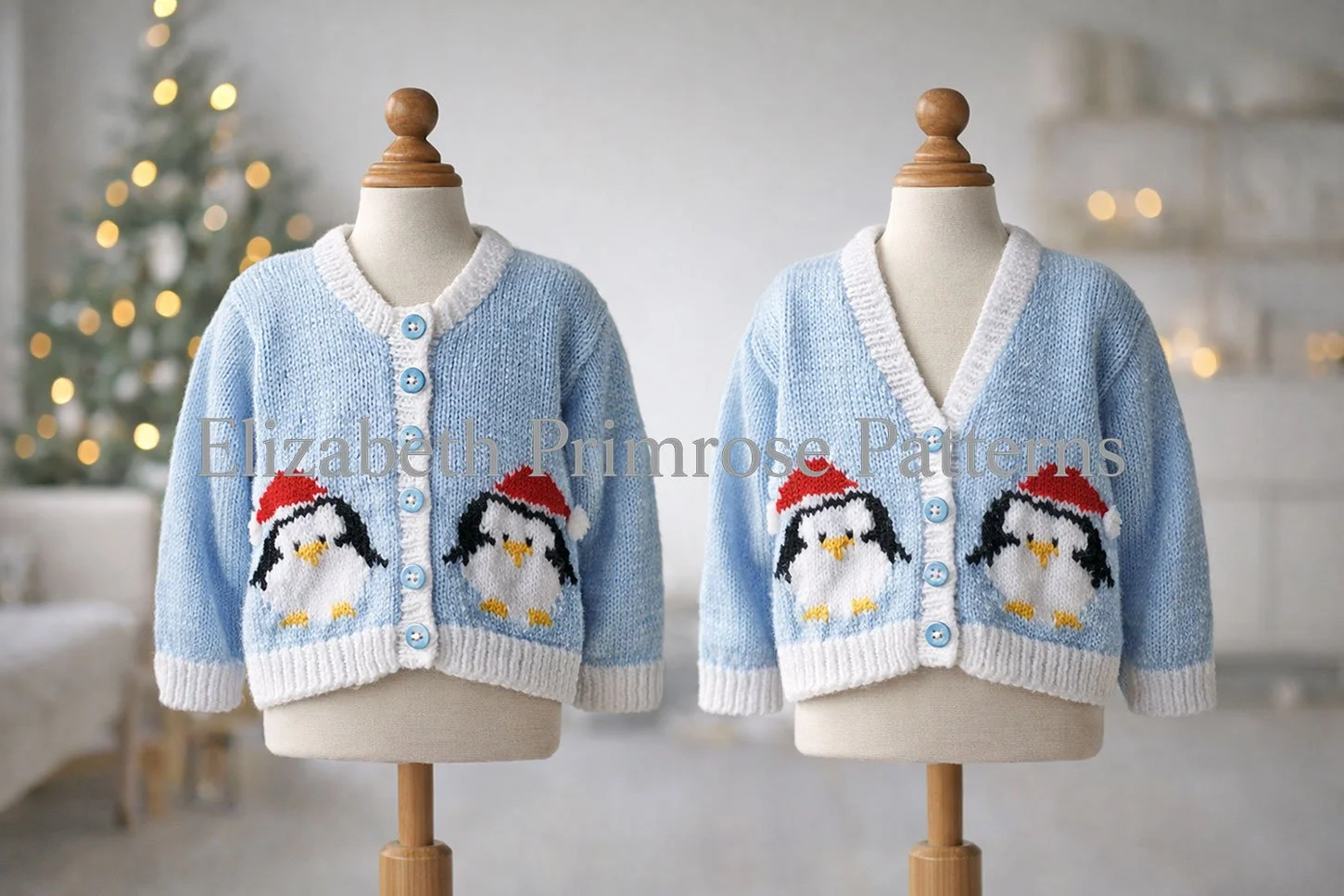 Light blue children’s cardigans on wooden mannequins, featuring two penguins in Santa hats, softly lit with a blurred Christmas tree in the background.