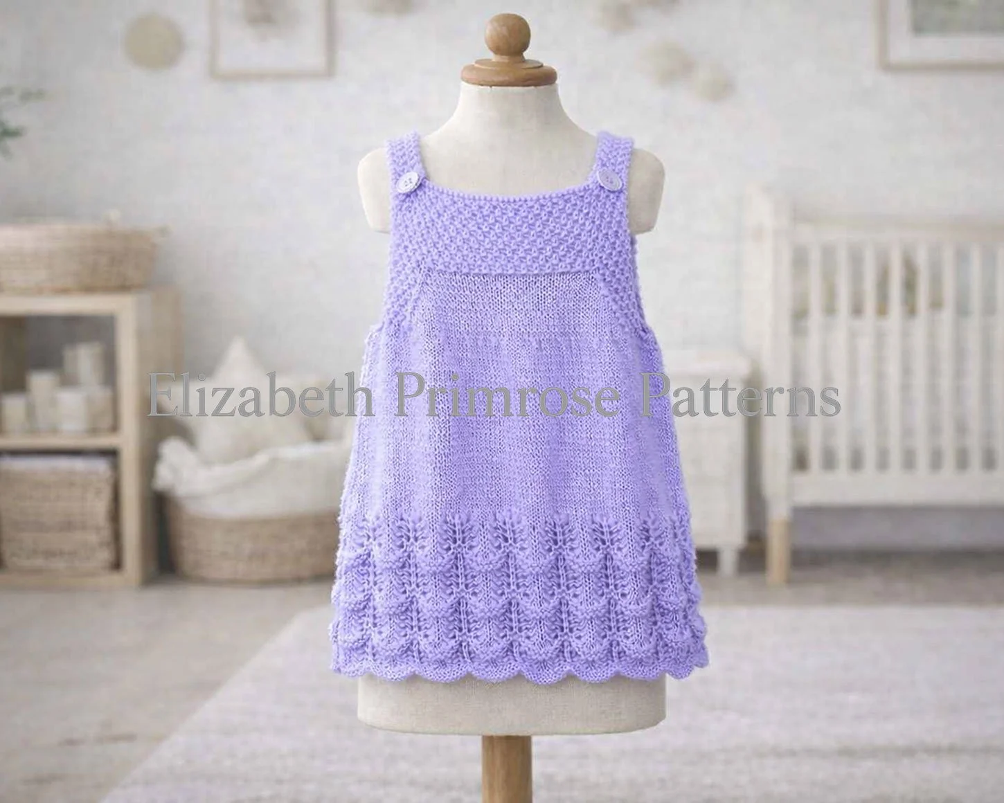 Hand‑knitted lilac dress with textured bodice and scalloped lace hem shown on a beige fabric mannequin in a calm nursery room.