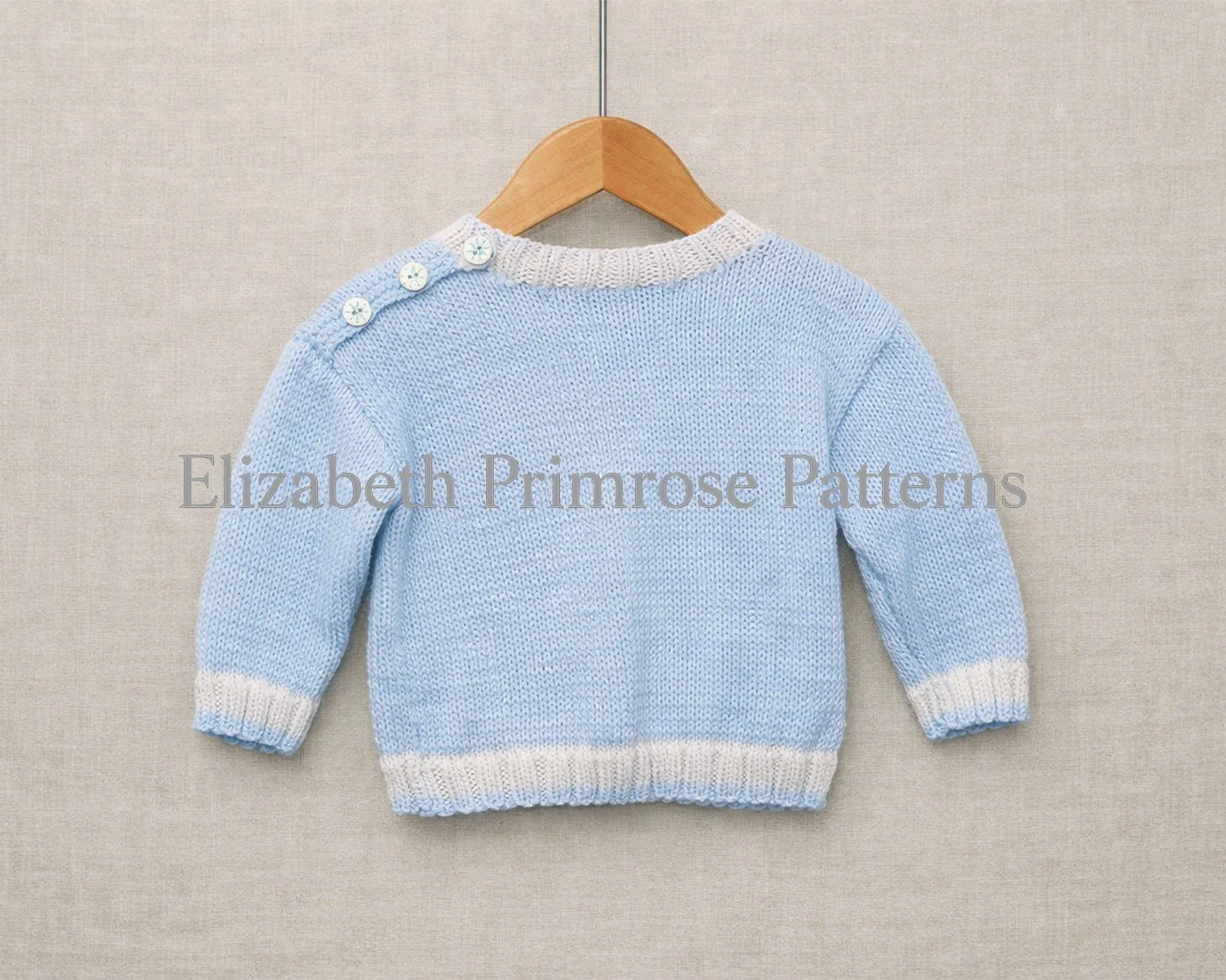 Light blue baby jumper shown from the back on a wooden hanger, with cream ribbing and three decorative buttons on the shoulder.