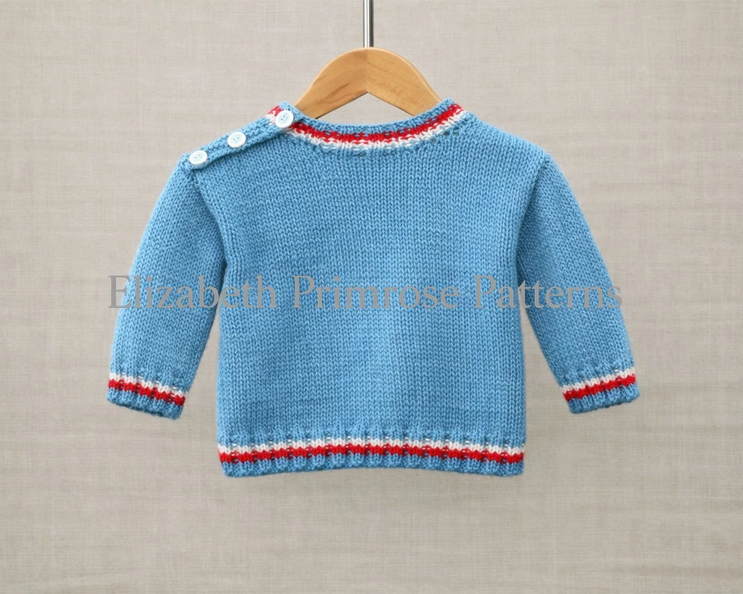 Back of a light blue baby jumper on a wooden hanger, showing simple shaping and striped trims against a soft fabric background.