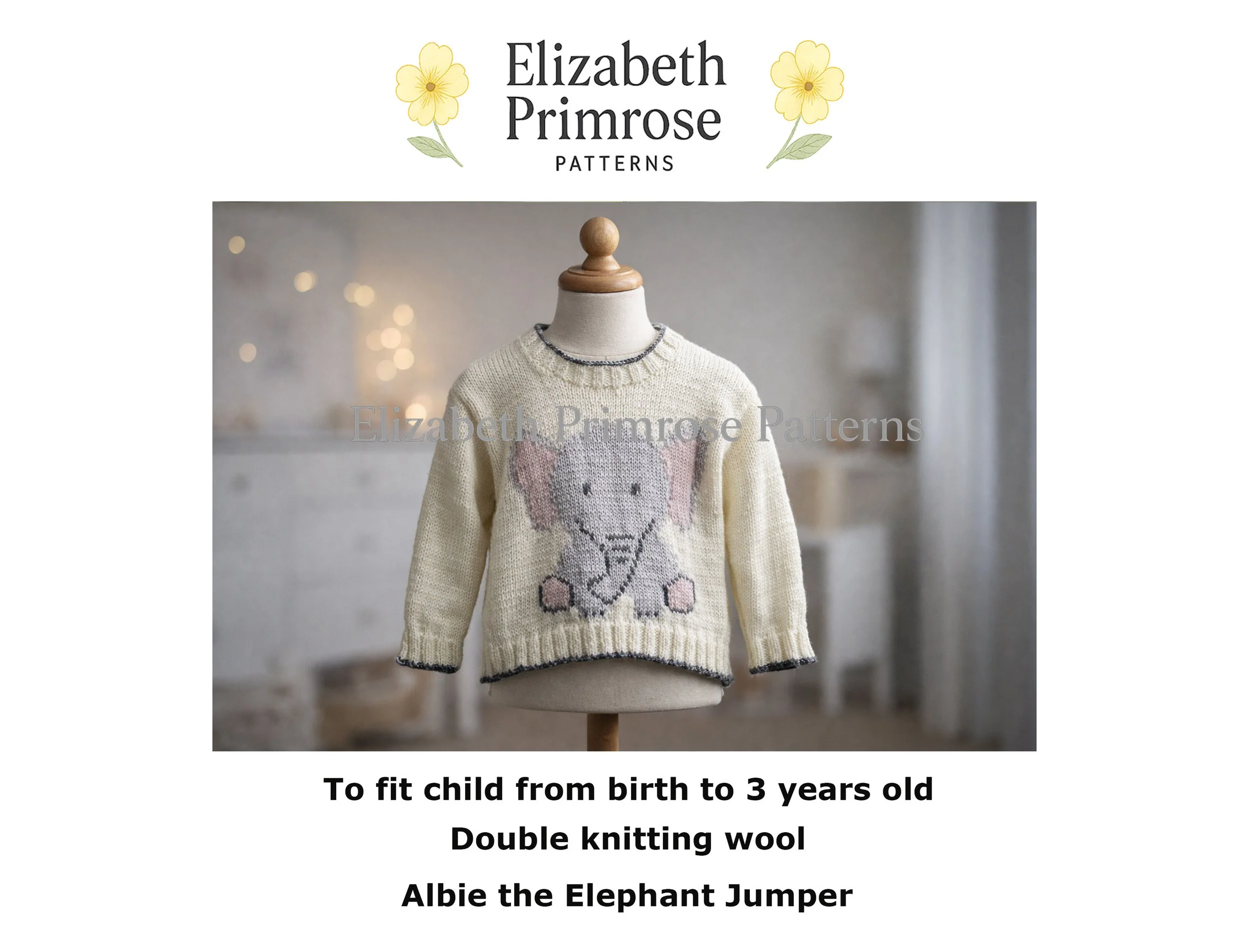 Cream knitted baby jumper on a wooden mannequin featuring a grey elephant motif with pink accents, shown in a softly lit neutral nursery background.