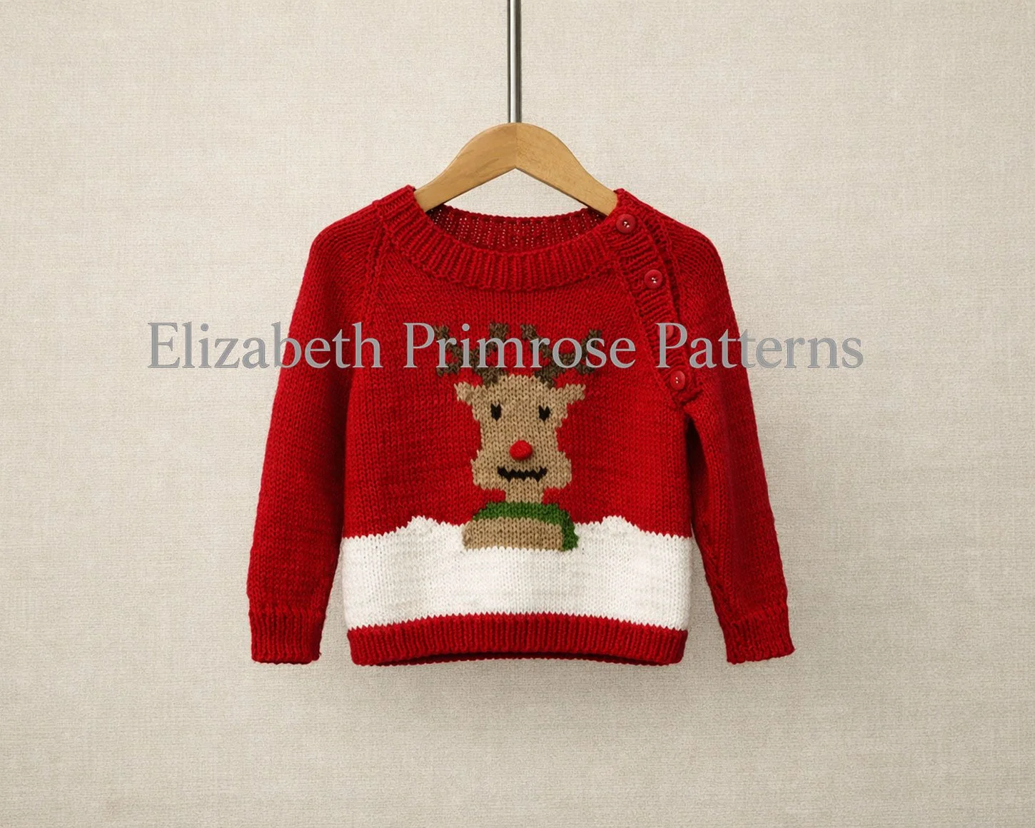 Festive red knitted jumper with Rudolph motif, four shoulder buttons, and white snowy band, displayed neatly on a hanger against a neutral backdrop.