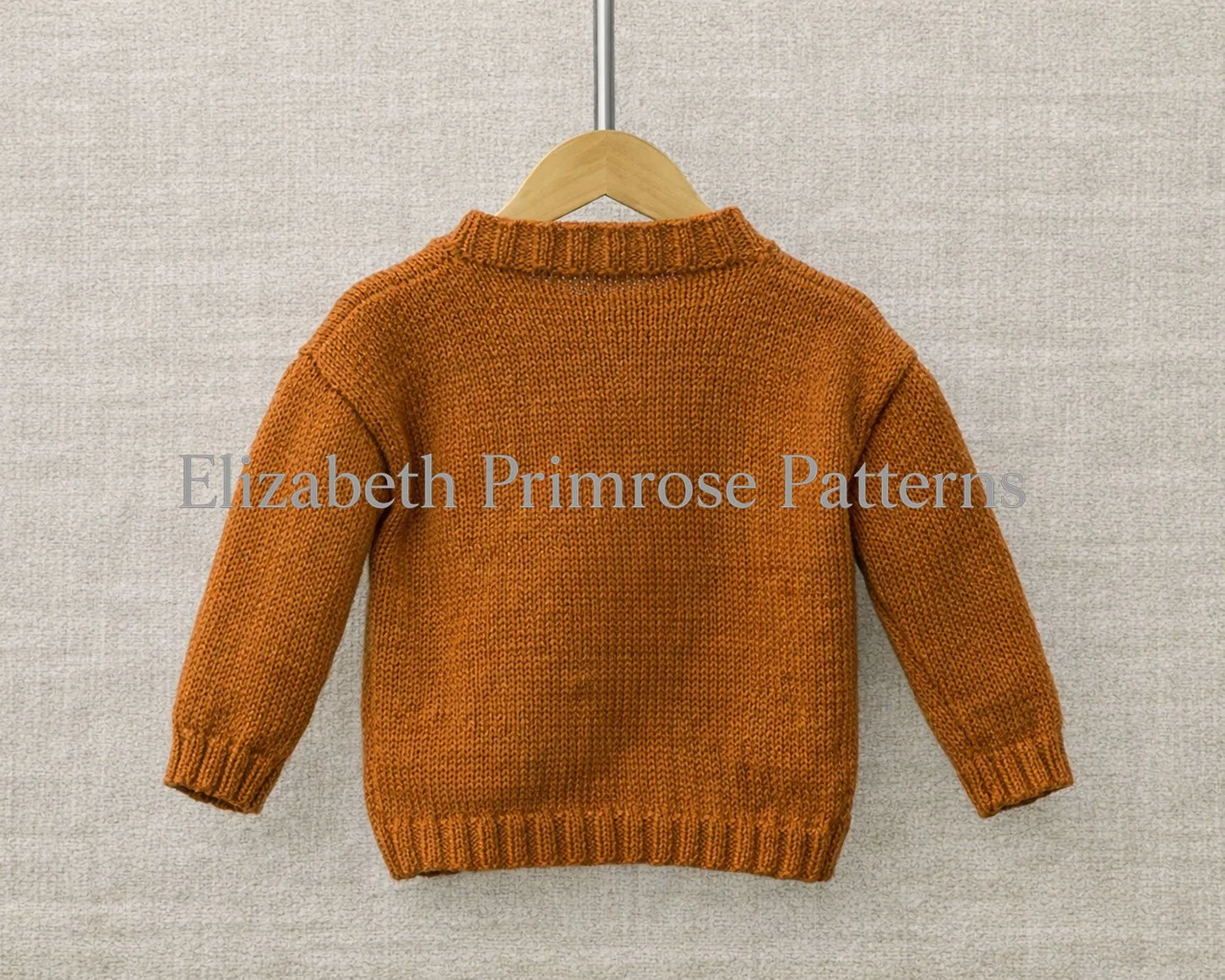 Back view of orange knitted jumper, displayed on a wooden hanger with a warm, neutral textured backdrop.