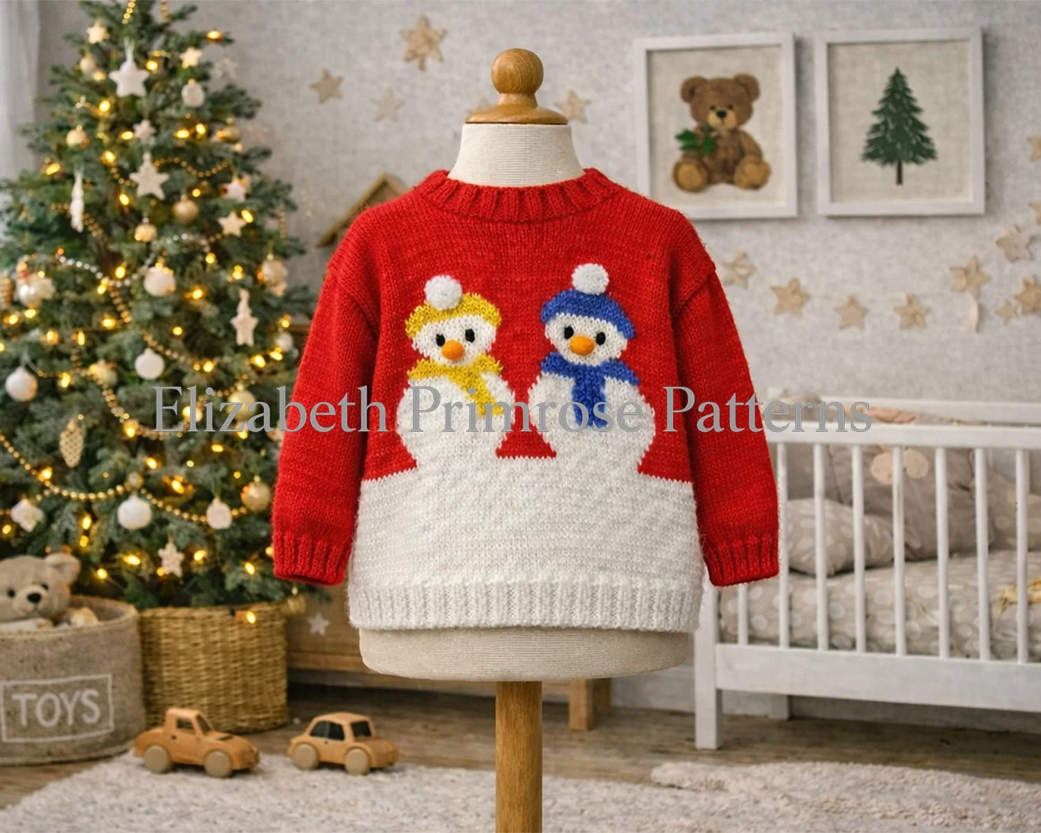 Children’s snowman jumper displayed on a mannequin in a warm Christmas nursery scene, with a decorated tree, framed prints and wooden toys in the background.
