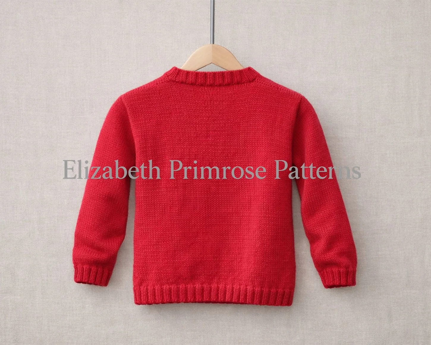 Red children’s knitted jumper shown from the back, hanging on a wooden hanger against a soft beige fabric background.