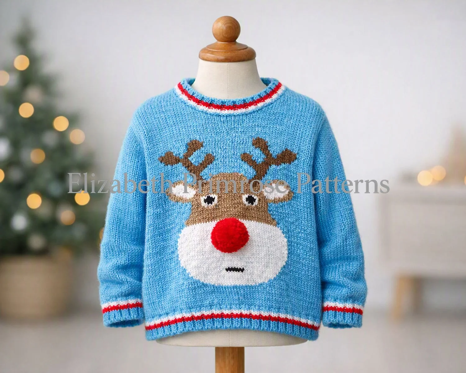 Blue hand knitted reindeer jumper on child mannequin with wooden top, softly draped sleeves, Scandinavian Christmas room background.