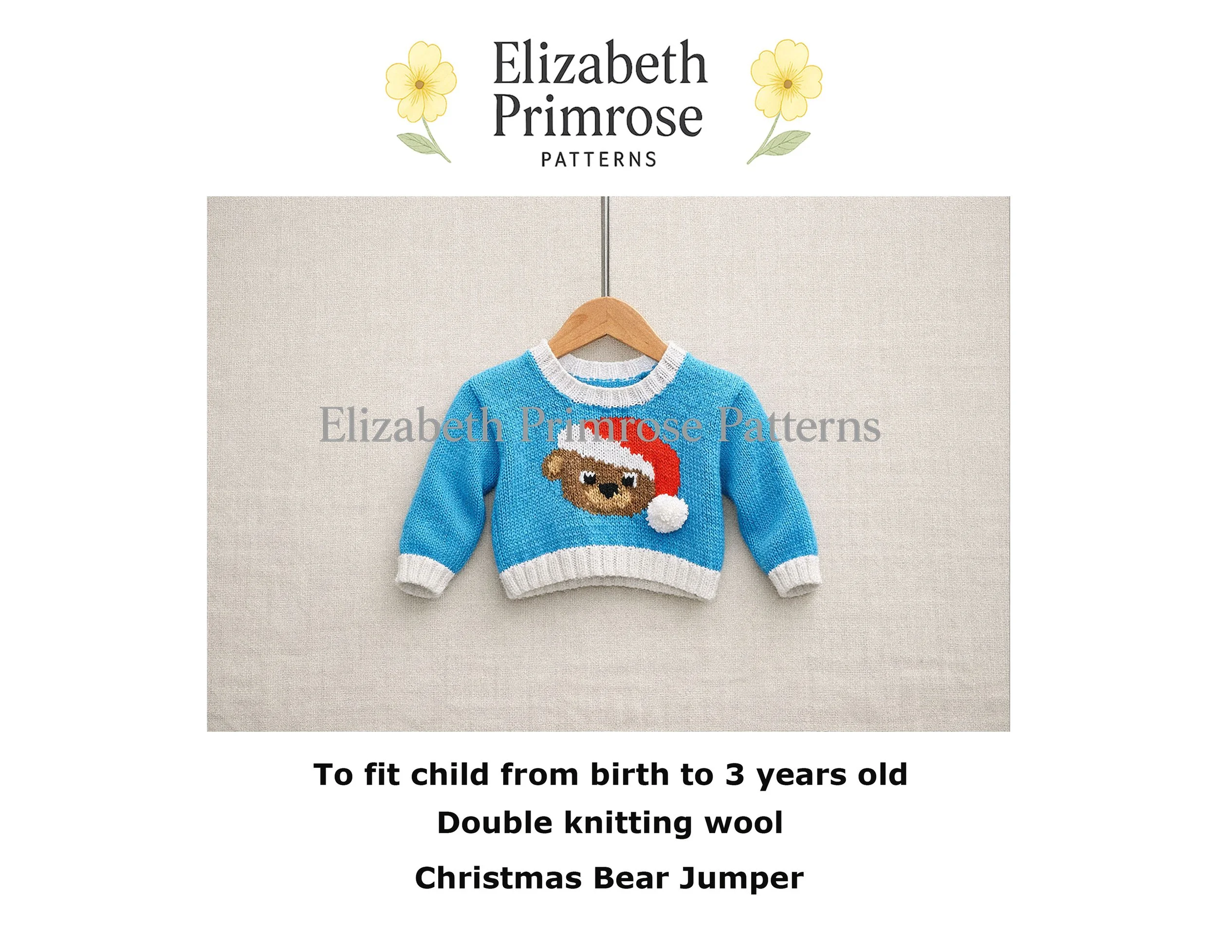 Light blue knitted children’s jumper on a wooden hanger, featuring an intarsia bear wearing a red Christmas hat, displayed against a soft beige linen background.