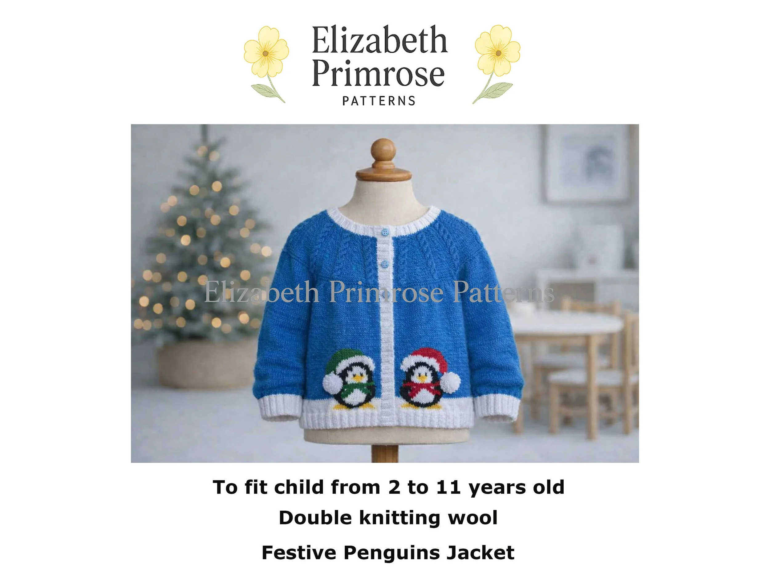 Blue hand knitted children’s cardigan on a mannequin, white trim and penguin motifs, shown in a softly lit Christmas room with blurred tree and warm festive ambience.