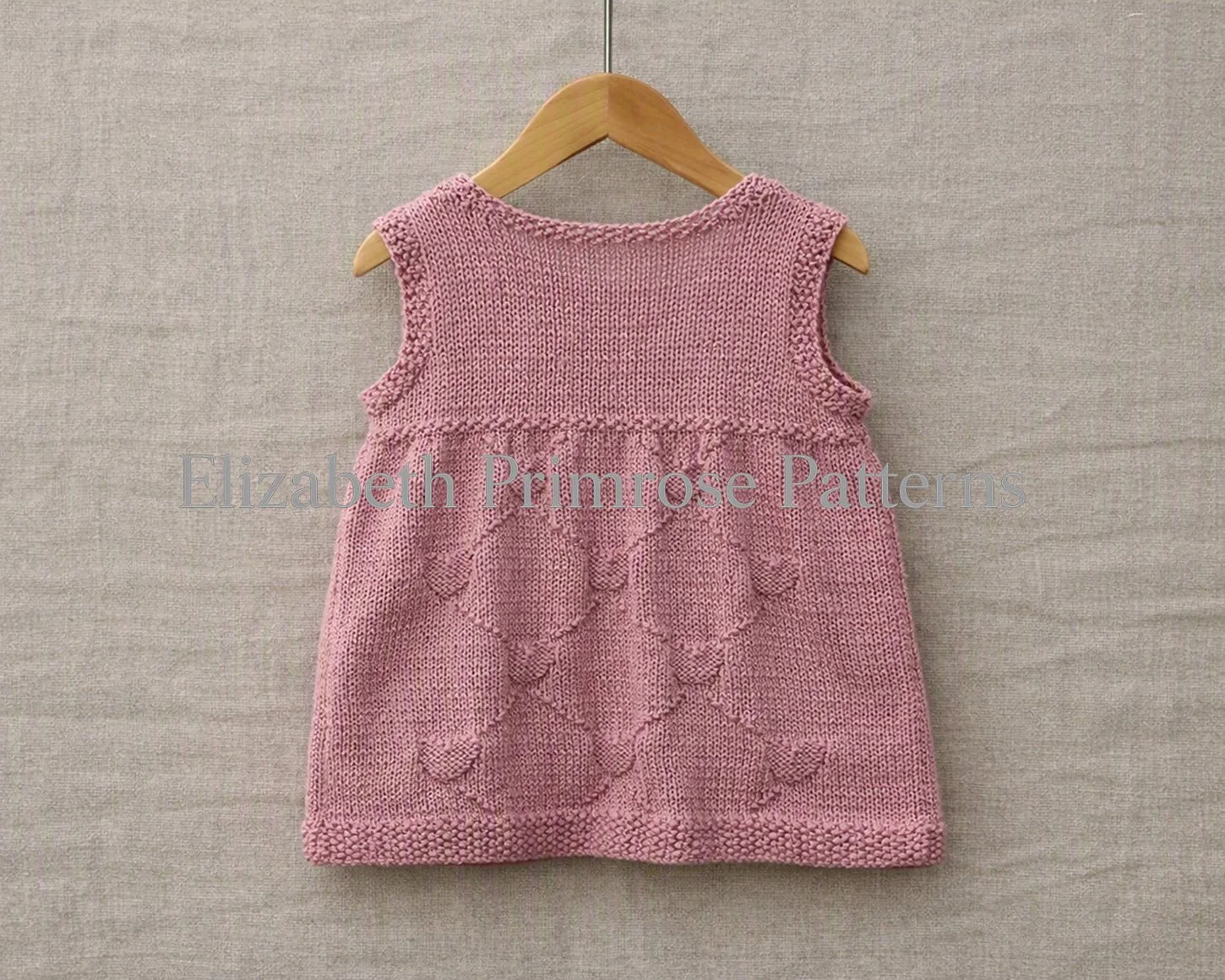 Elizabeth Primrose Patterns Diamond Hearts sleeveless child dress knitting pattern P160 back view in Sirdar Snuggly DK shade Precious.