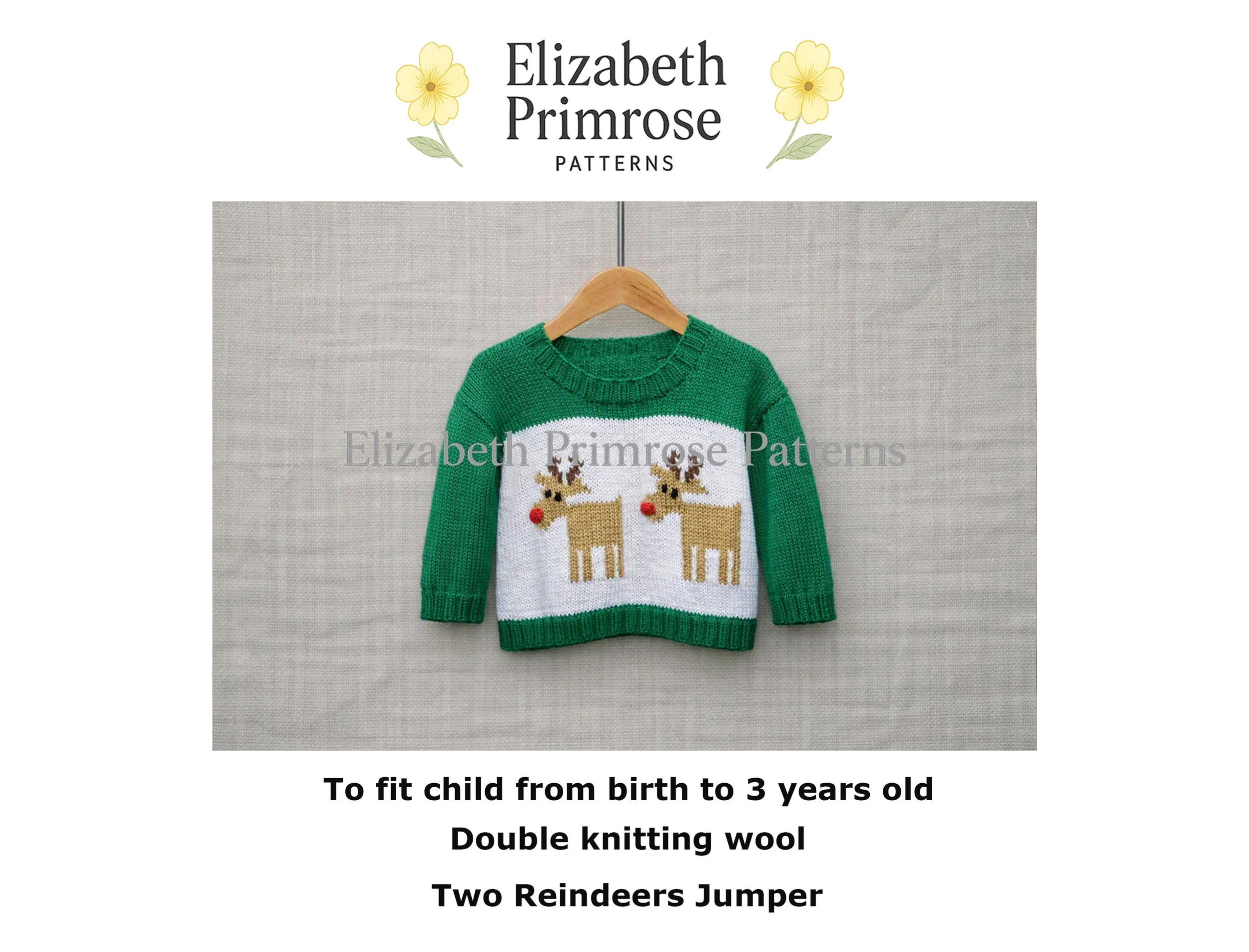 Green knitted children’s jumper with two reindeer motifs on white chest panel, hanging on wooden hanger against light fabric background.