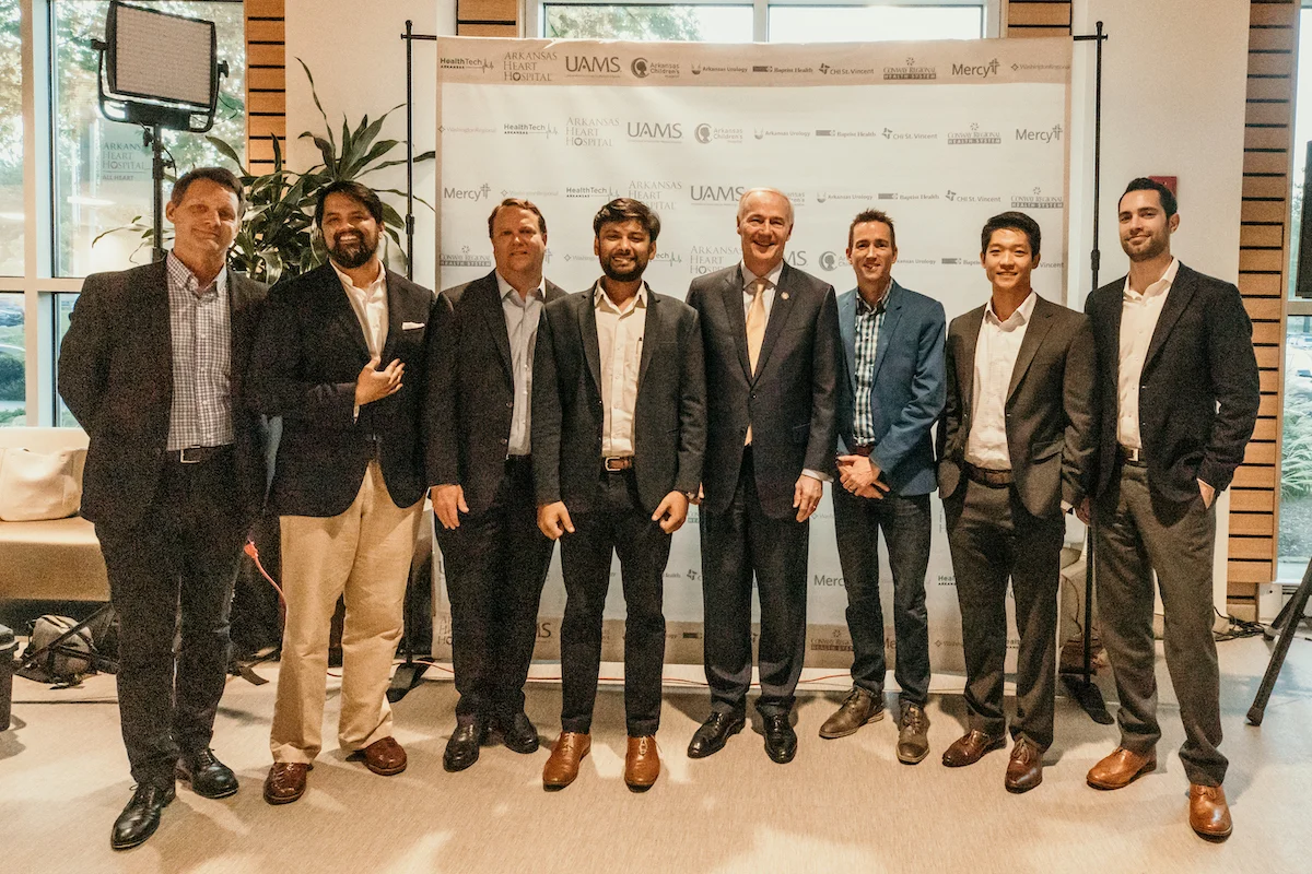 From left to right: Dr. Matt Banet with toSense, Dr. Mitesh Rao with OMNY Health, Ken Nelson with Bardy Dx, Dr. Mayur Saxena with Droice Labs, Governor Asa Hutchinson, Director of HealthTech Arkansas Jeff Stinson, Dr. Adeel Yang with Medumo, and Dr. Josh Reischer with Health Note.