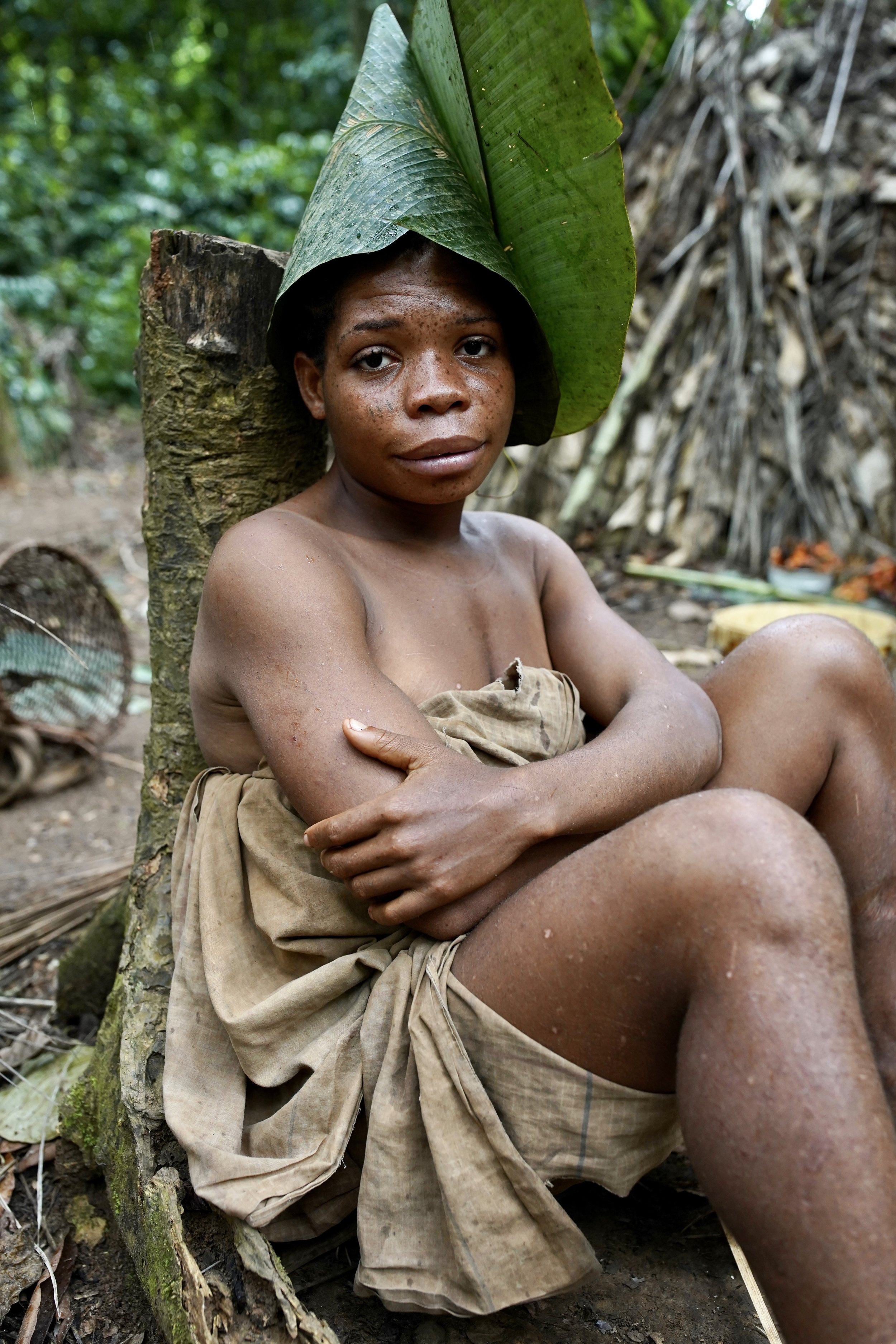 Baka Pygmy woman wearing a rain hat made from jungle leaves. Cameroon 