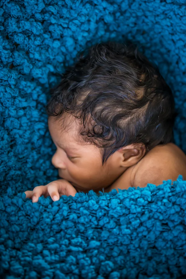 Baby sleeping under blue blanket