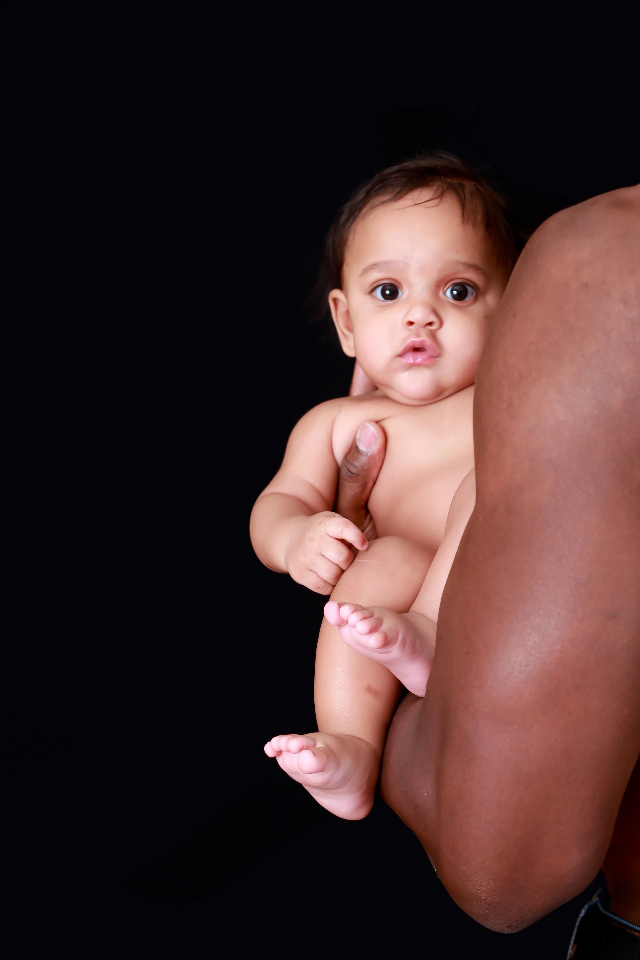 Baby in his father's left arm