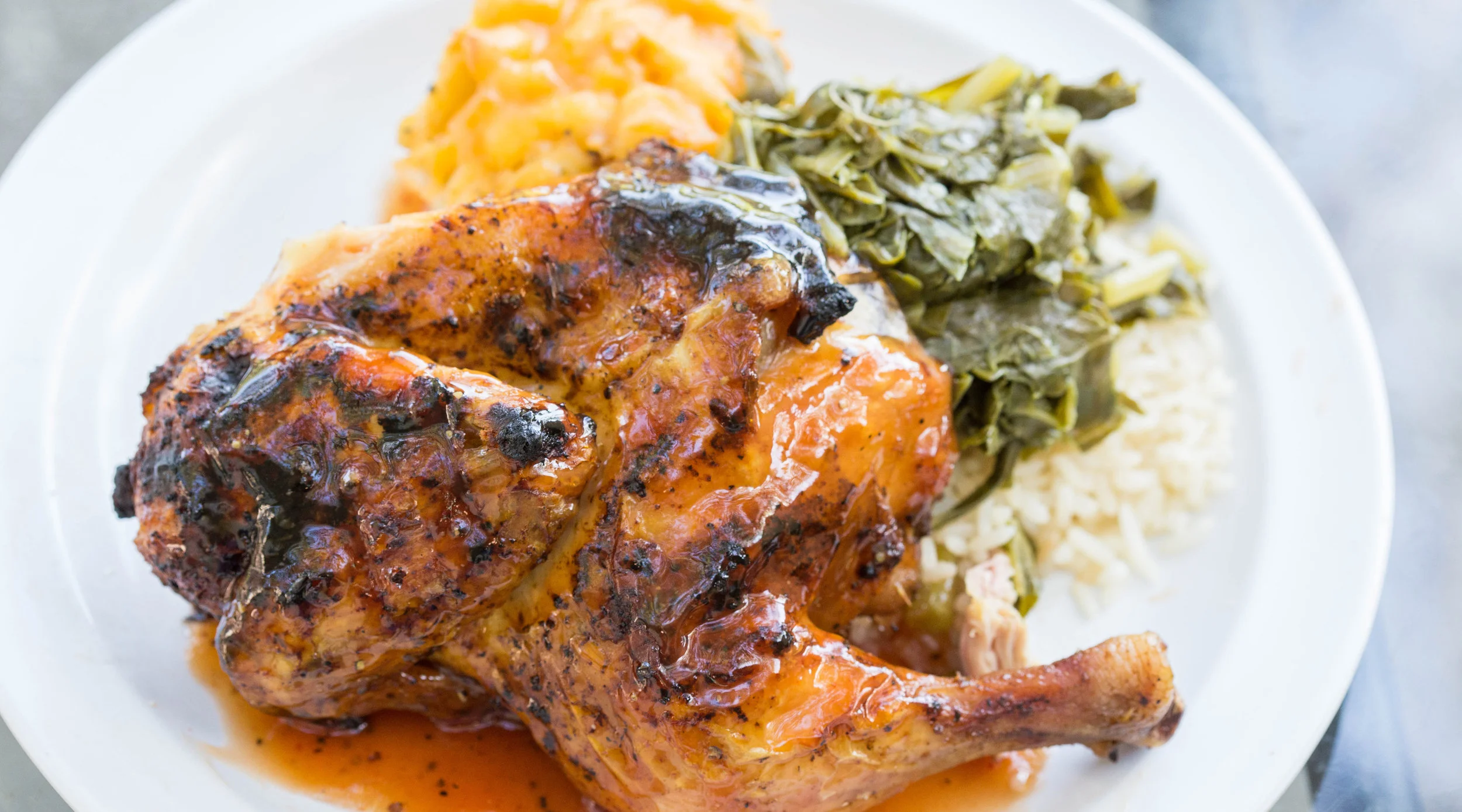 Plate of barbecue chicken and side dishes