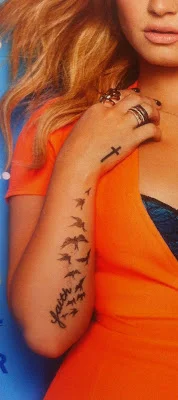 One way or another, Demi’s cross is upside down.