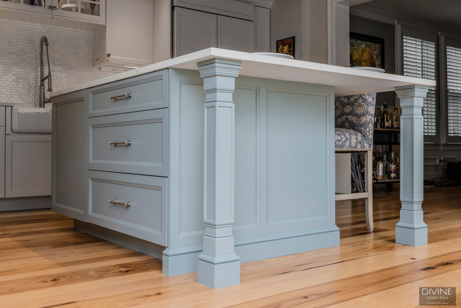  Blue traditional style kitchen island with cambria countertops and a bosch microwave integrated below the countertop