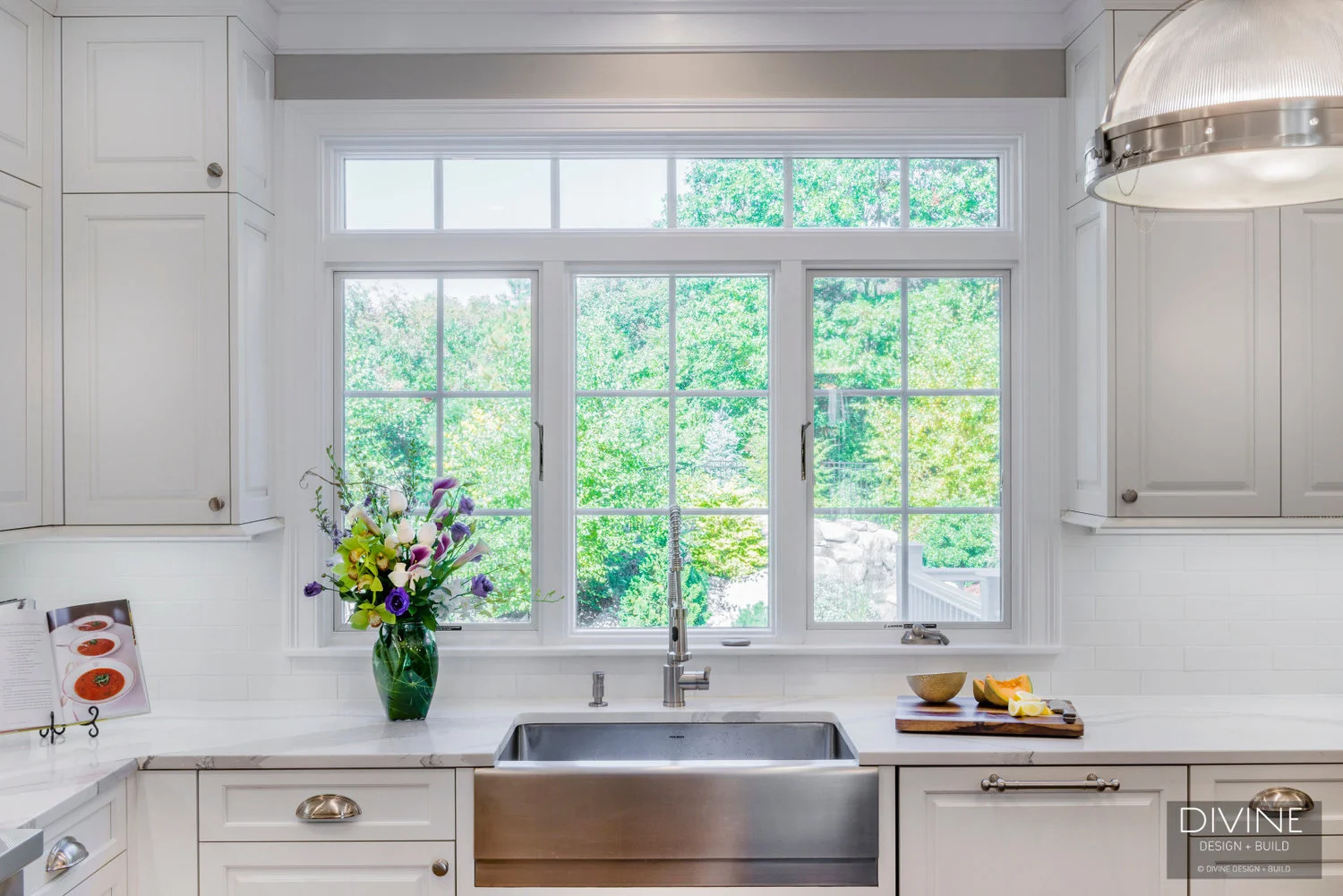  traditional shaker style kitchen. wolf appliances and chrome pendant lights. Calacatta countertops and medium hardwood floors. pull out pantry storage.