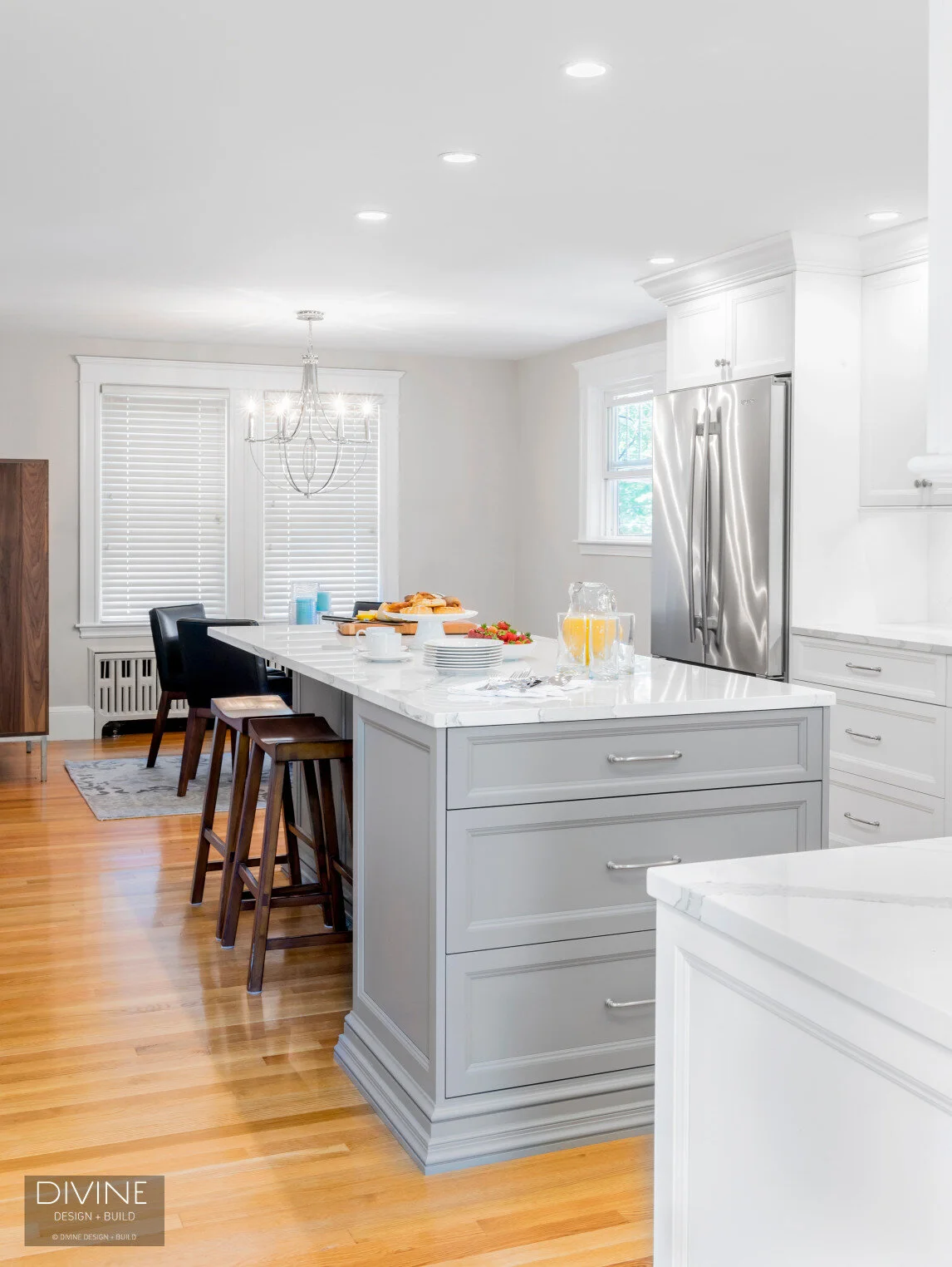 White and grey transitional style kitchen with shaker cabinets and stainless steel appliances. beveled subway tile backsplash in white. 