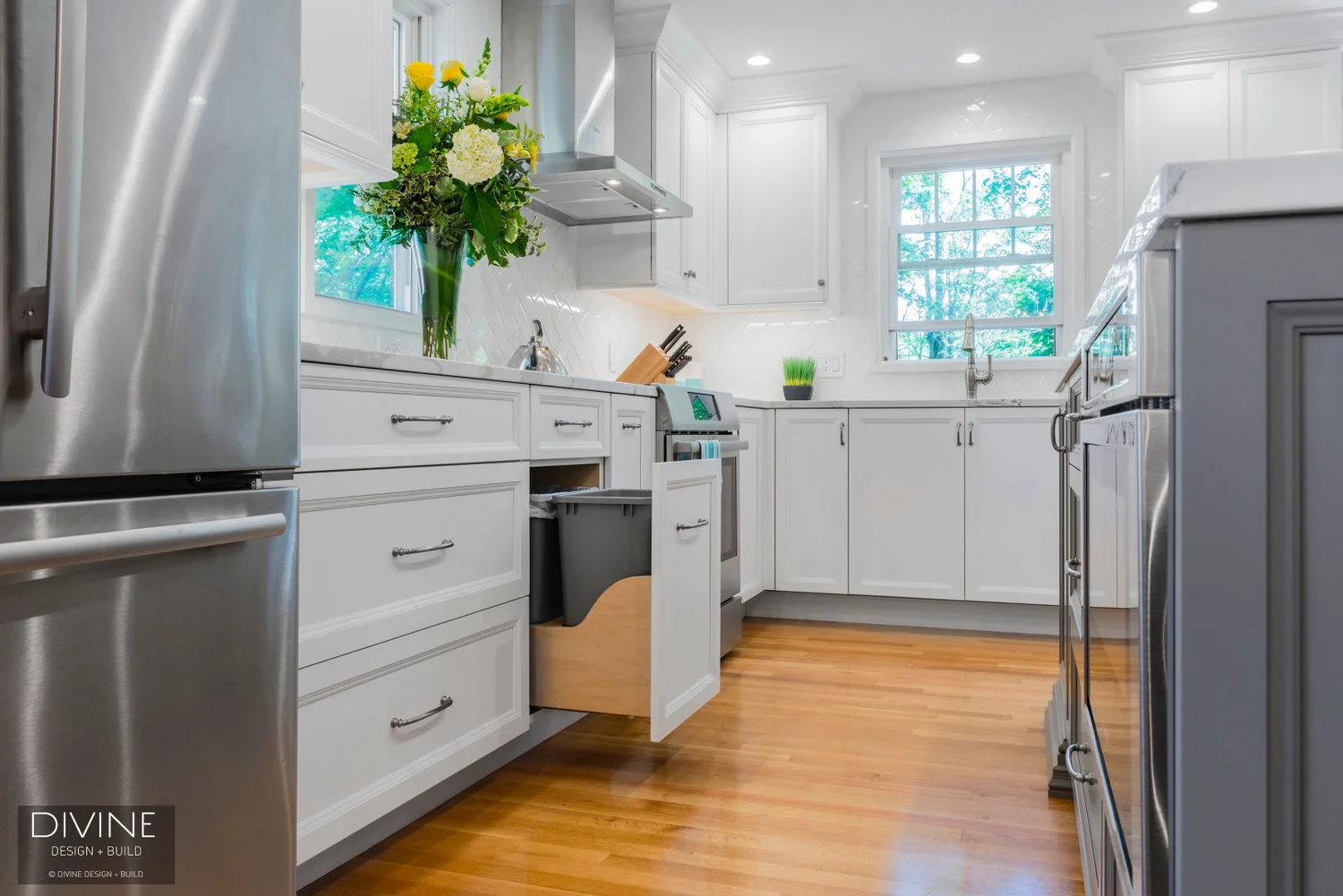 White and grey transitional style kitchen with shaker cabinets and stainless steel appliances. beveled subway tile backsplash in white. 