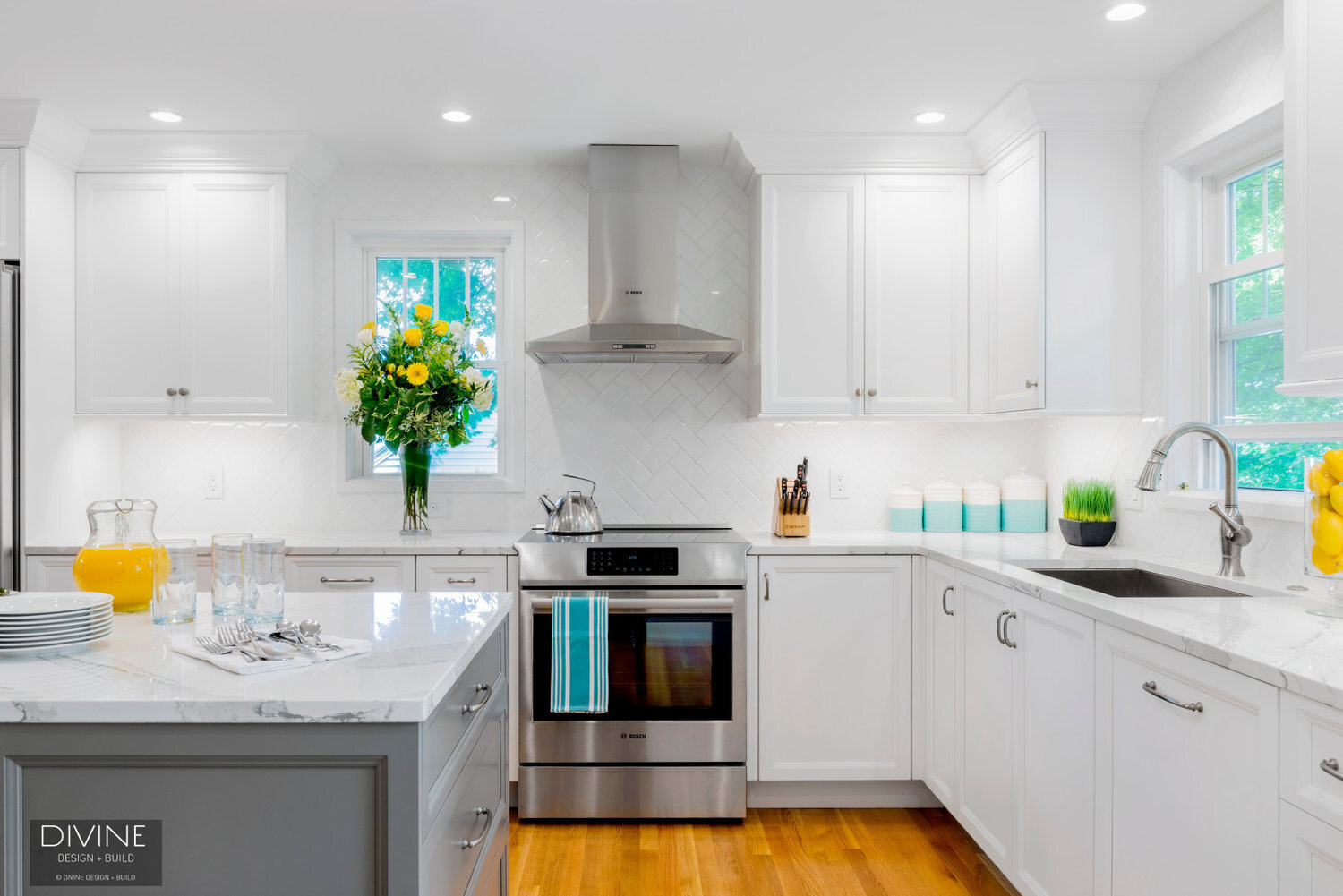White and grey transitional style kitchen with shaker cabinets and stainless steel appliances. beveled subway tile backsplash in white. 