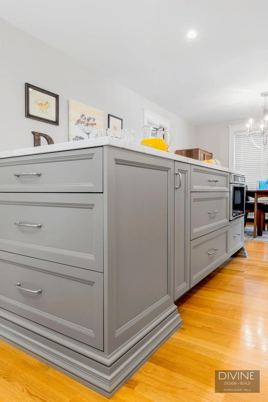 White and grey transitional style kitchen with shaker cabinets and stainless steel appliances. beveled subway tile backsplash in white. 